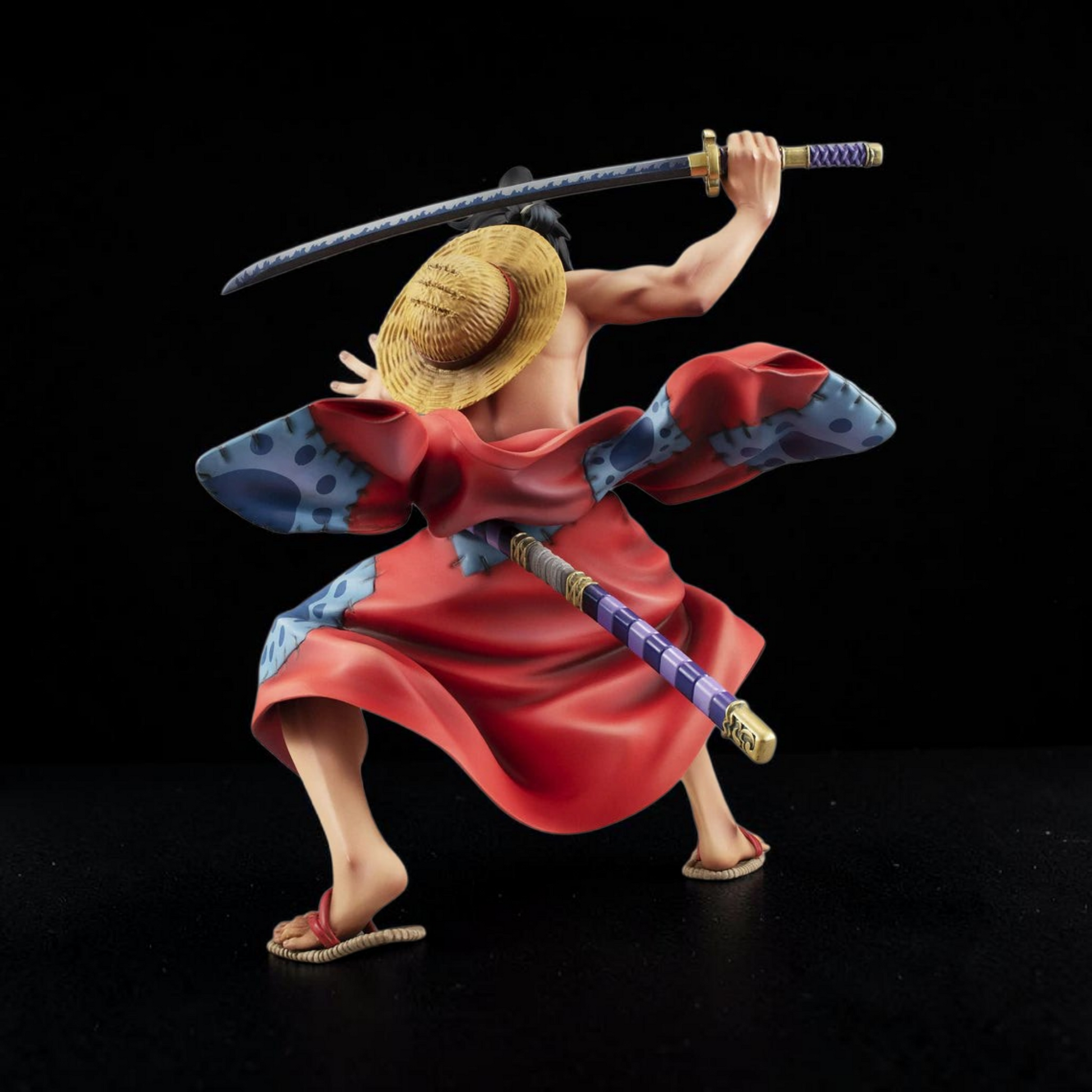 Figurine of a character from a popular anime series with a sword on a black background