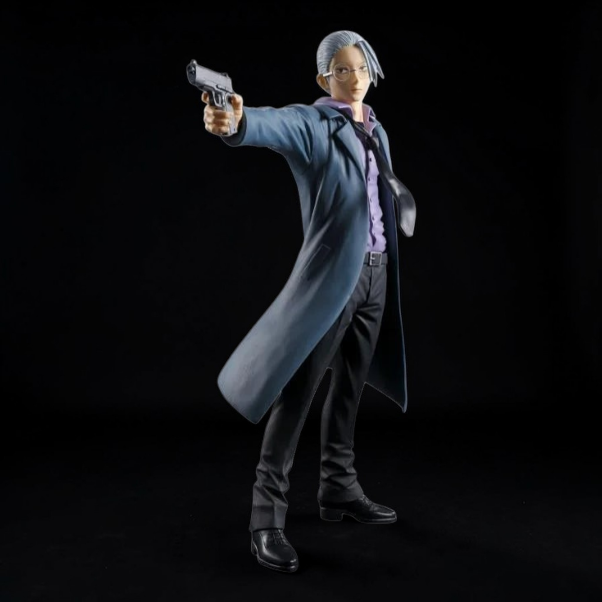 Action figure in a long coat holding a gun against a black background