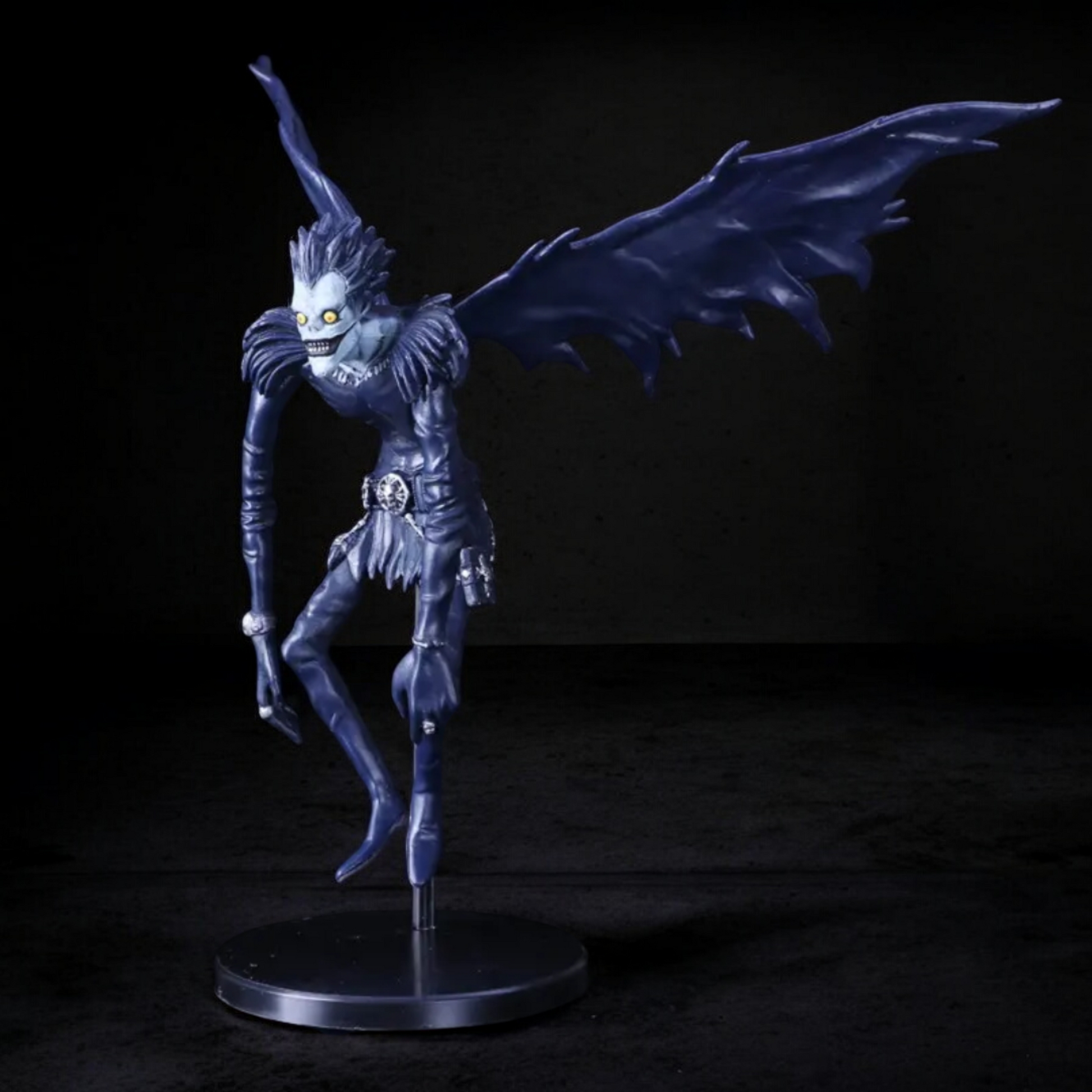 Dark fantasy figurine with wings on a black background