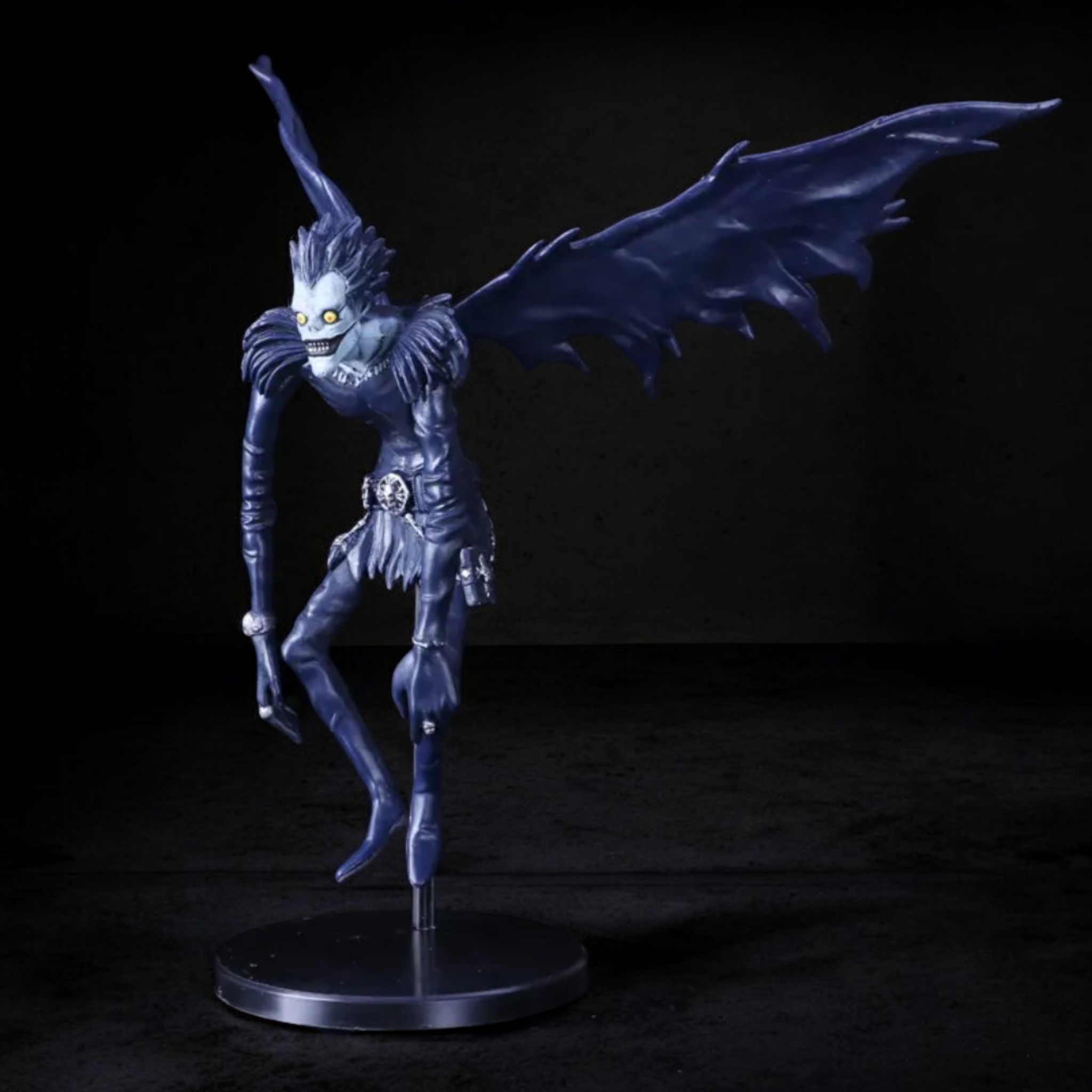 Dark fantasy figurine with wings on a black background