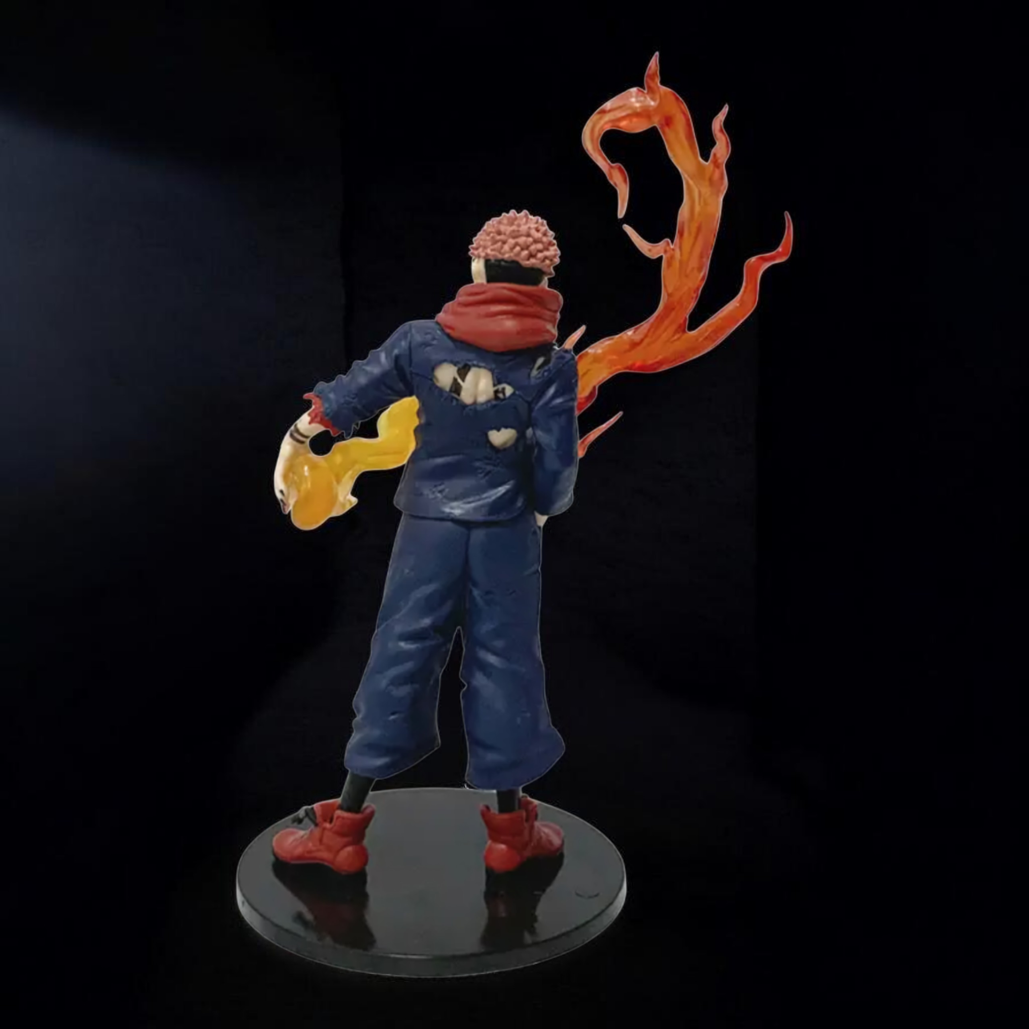 Action figure with blue outfit and red shoes on a black background