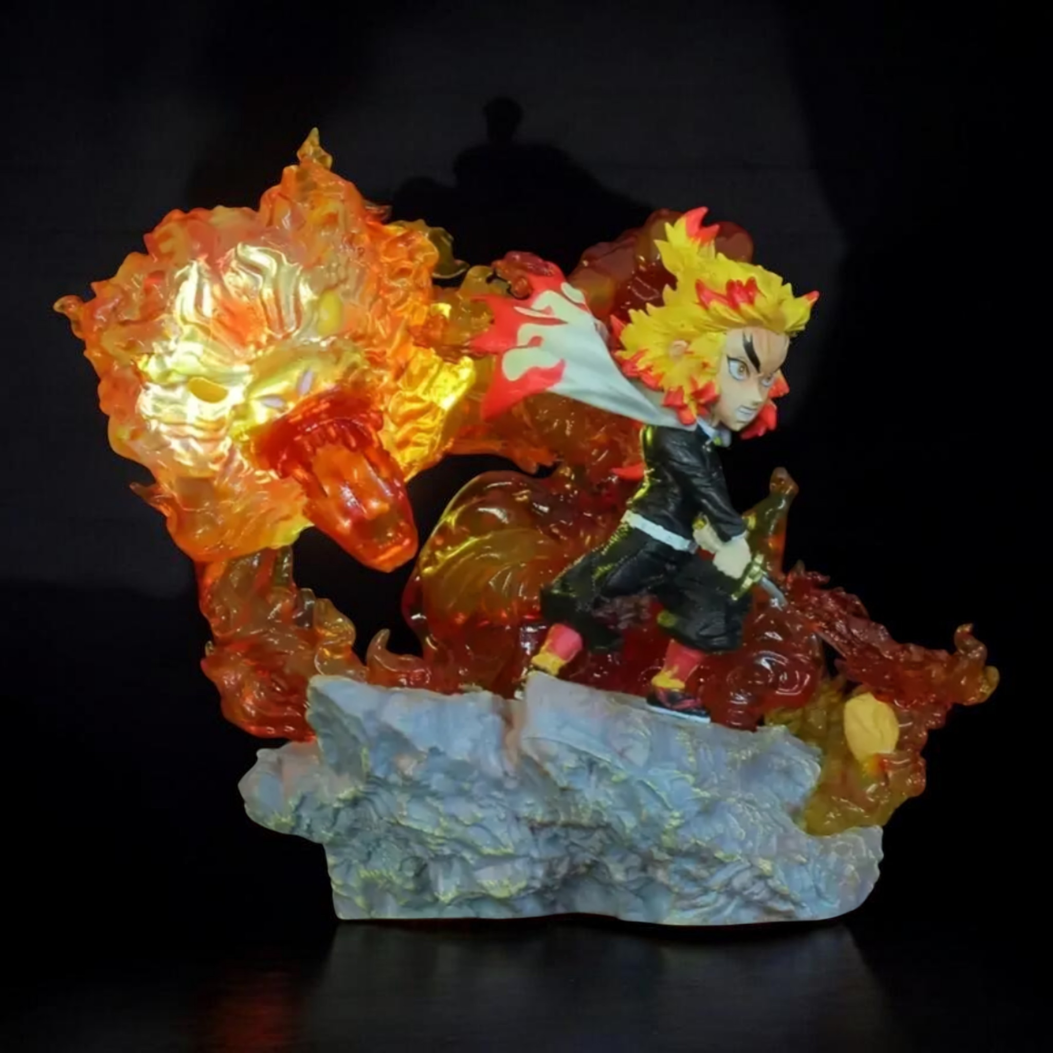 Colorful figurine with a character and fiery elements on a dark background
