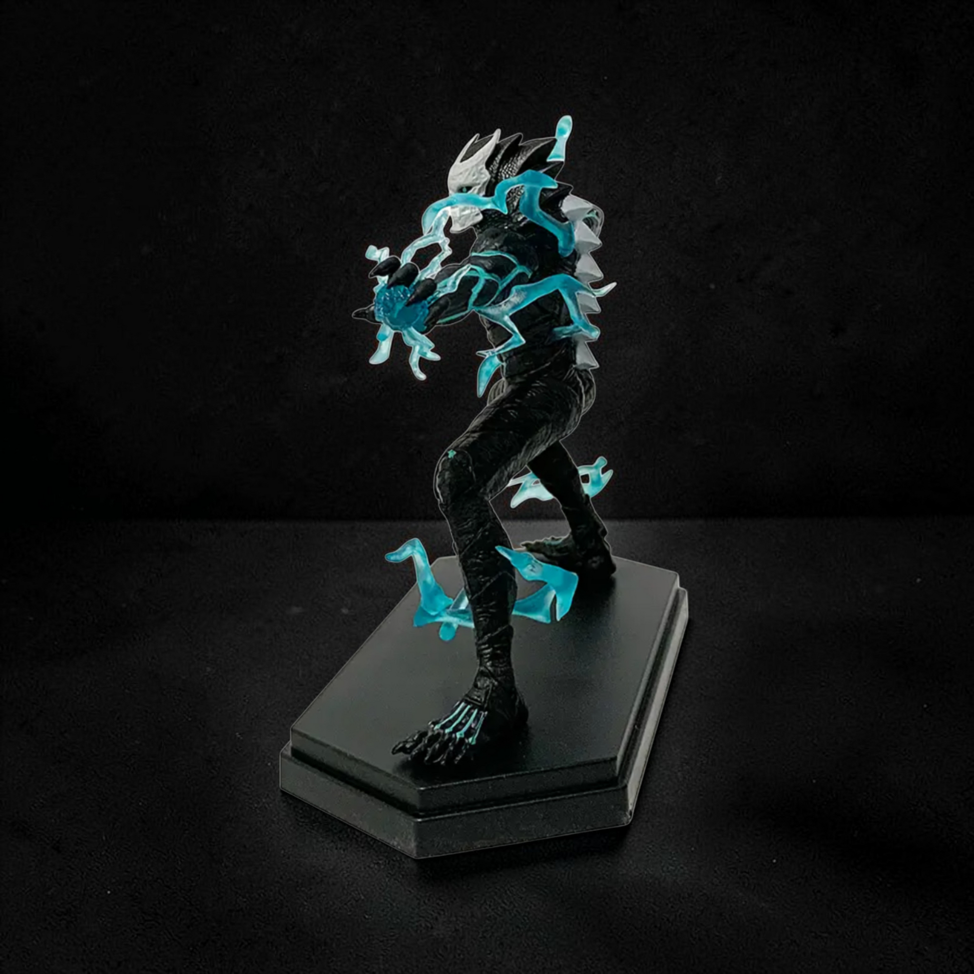 Fantasy figurine with glowing blue accents on a black stand against a dark background