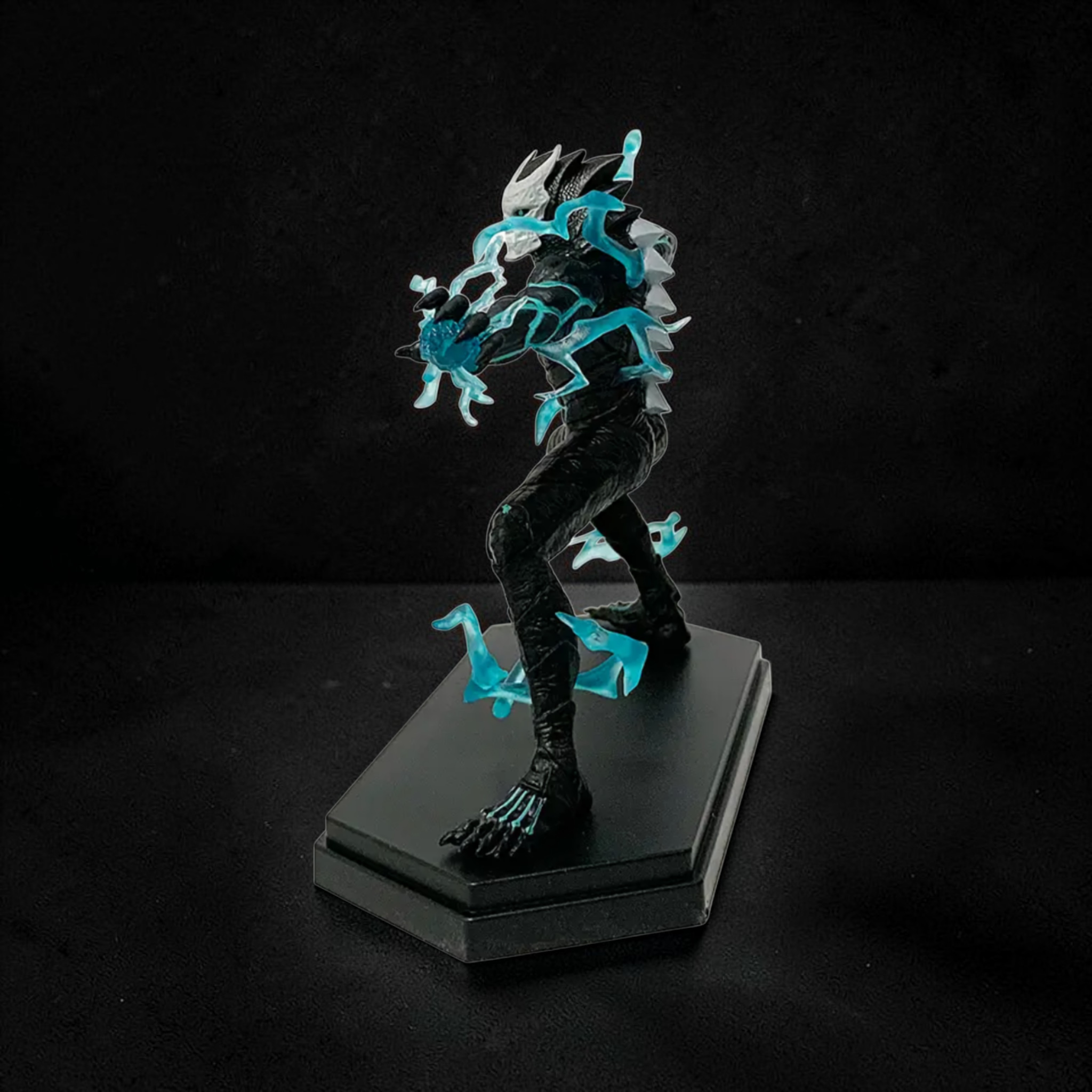 Fantasy figurine with glowing blue accents on a black stand against a dark background