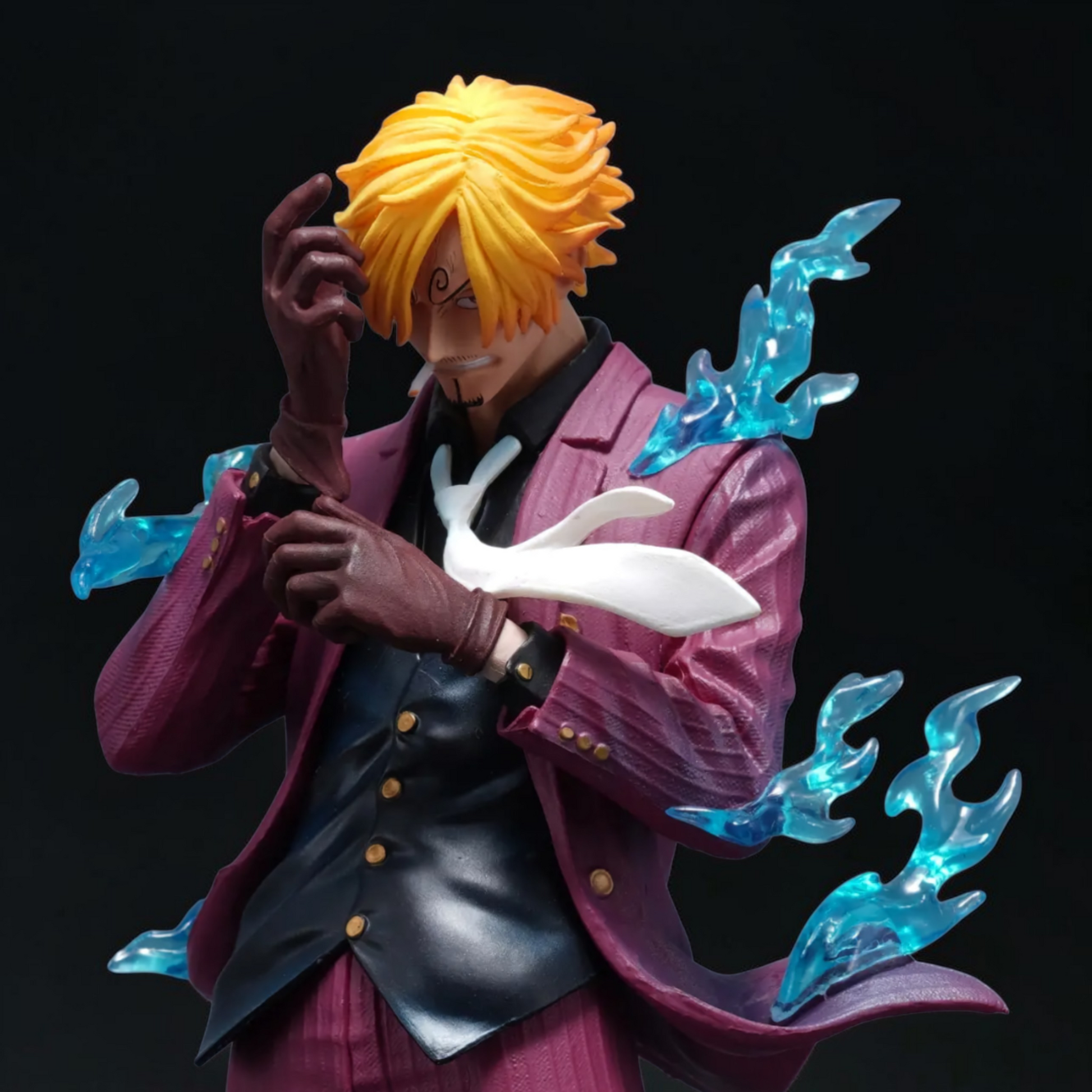 Figure of a character with yellow hair and a purple outfit, holding a white creature with blue energy effects on a black background.