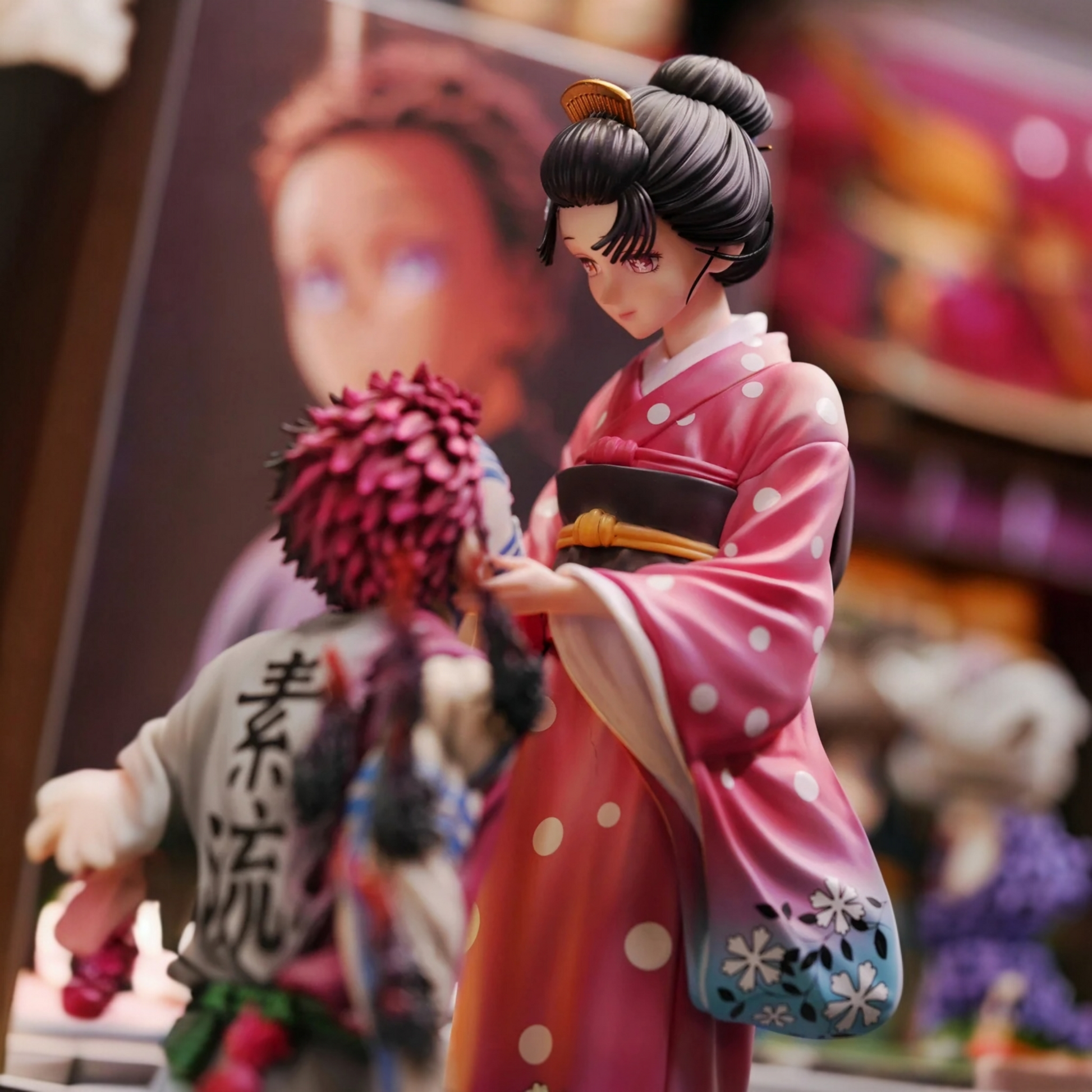 Two figurines in a dynamic pose against a blurred background