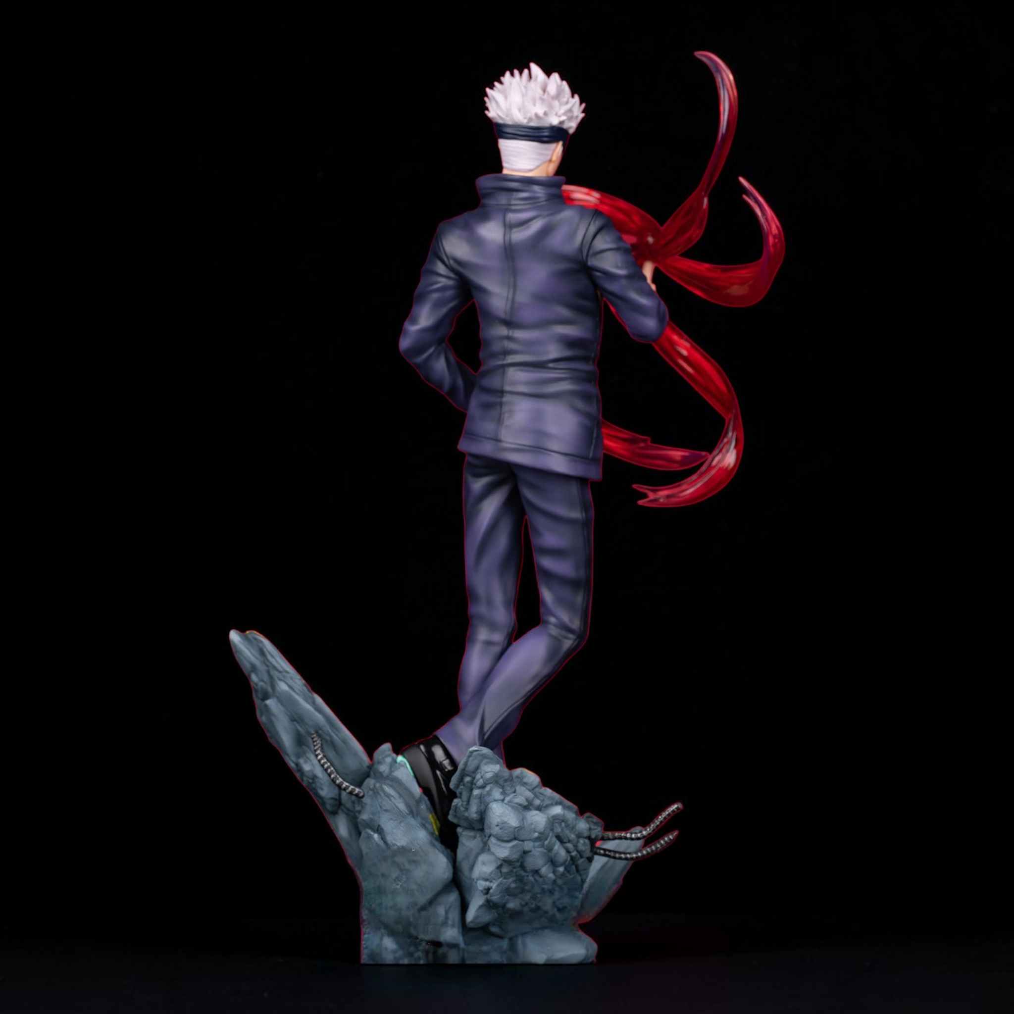 Statue of a character with red hair and white headband on a dark background