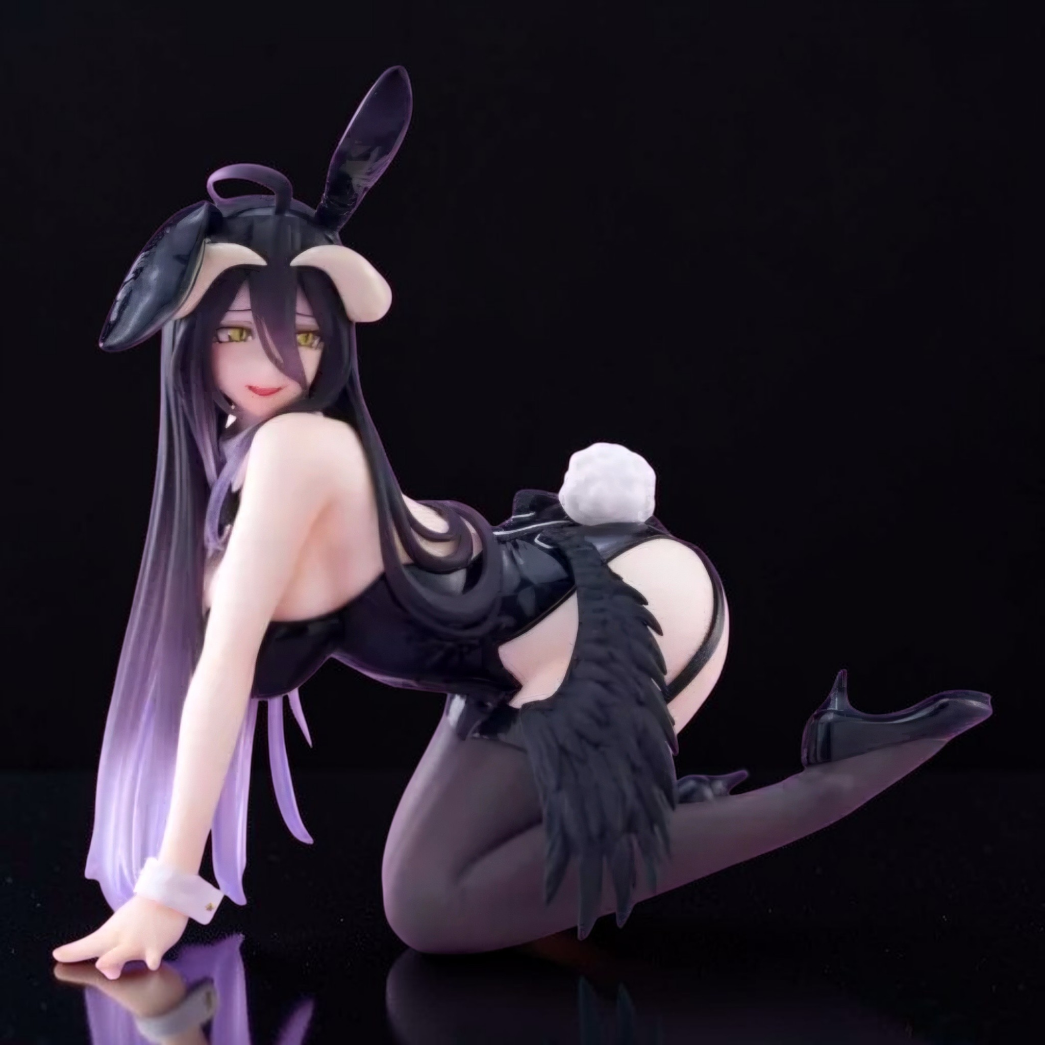 Anime character figurine with bunny ears and black outfit on a black background