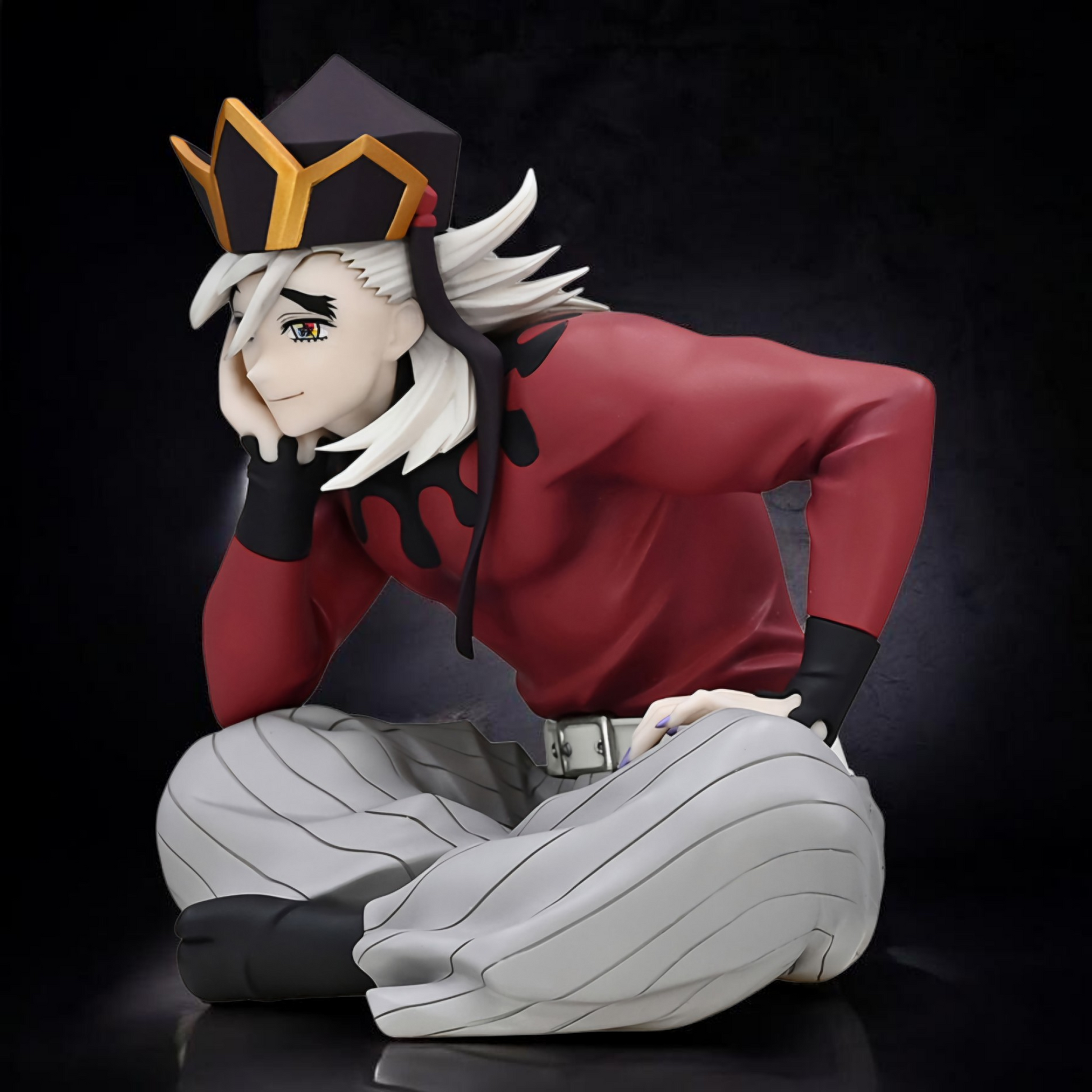 Anime character figurine with red outfit and white hair on a black background