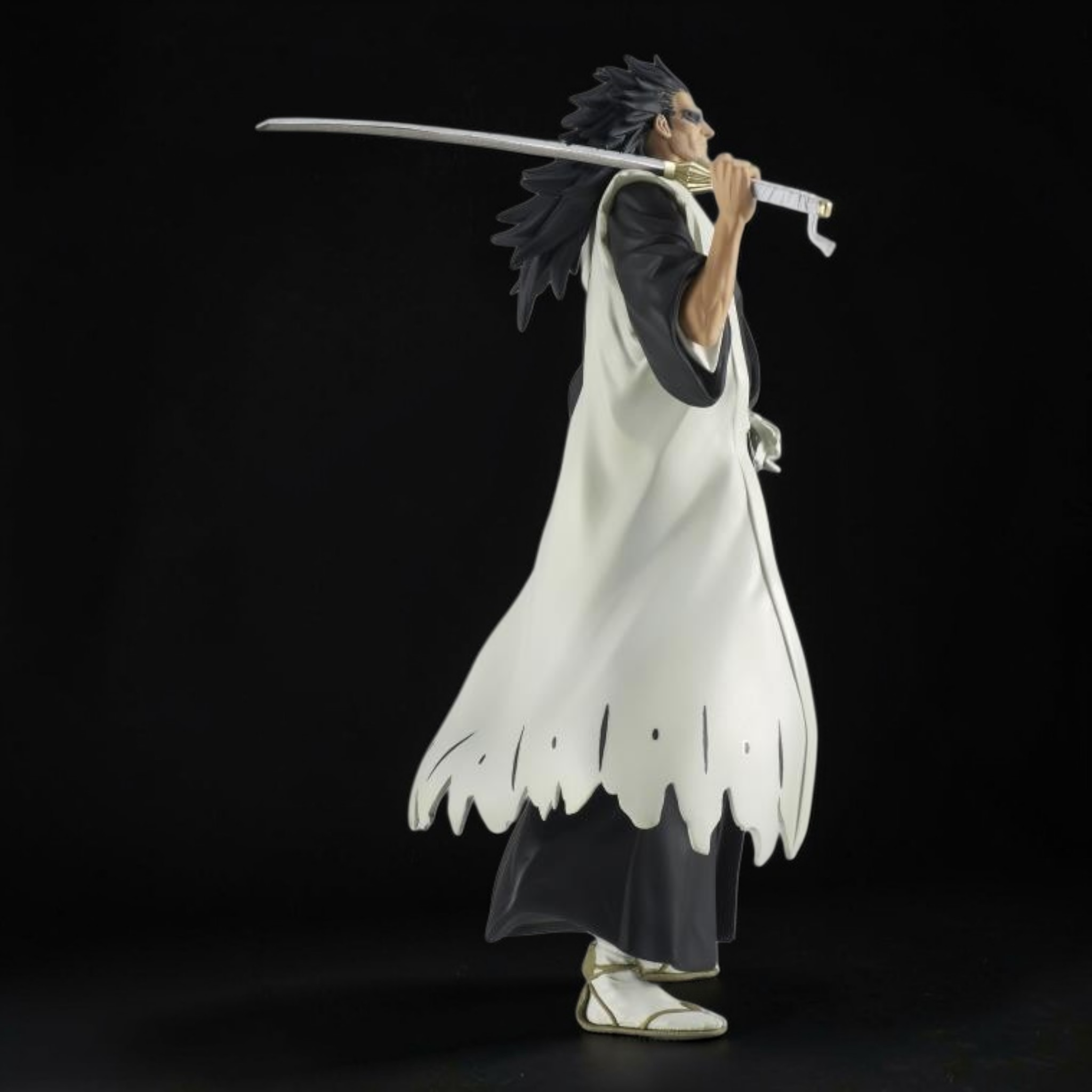 Figure of a character in a white outfit with a sword on a black background