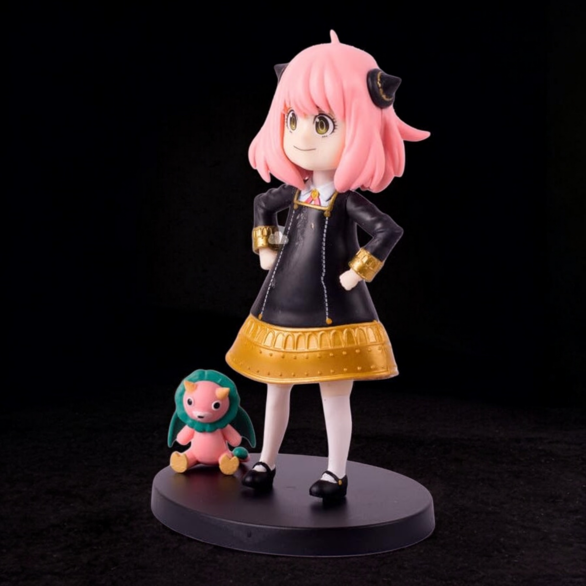 Figurine of an animated character with pink hair and a small creature on a black background