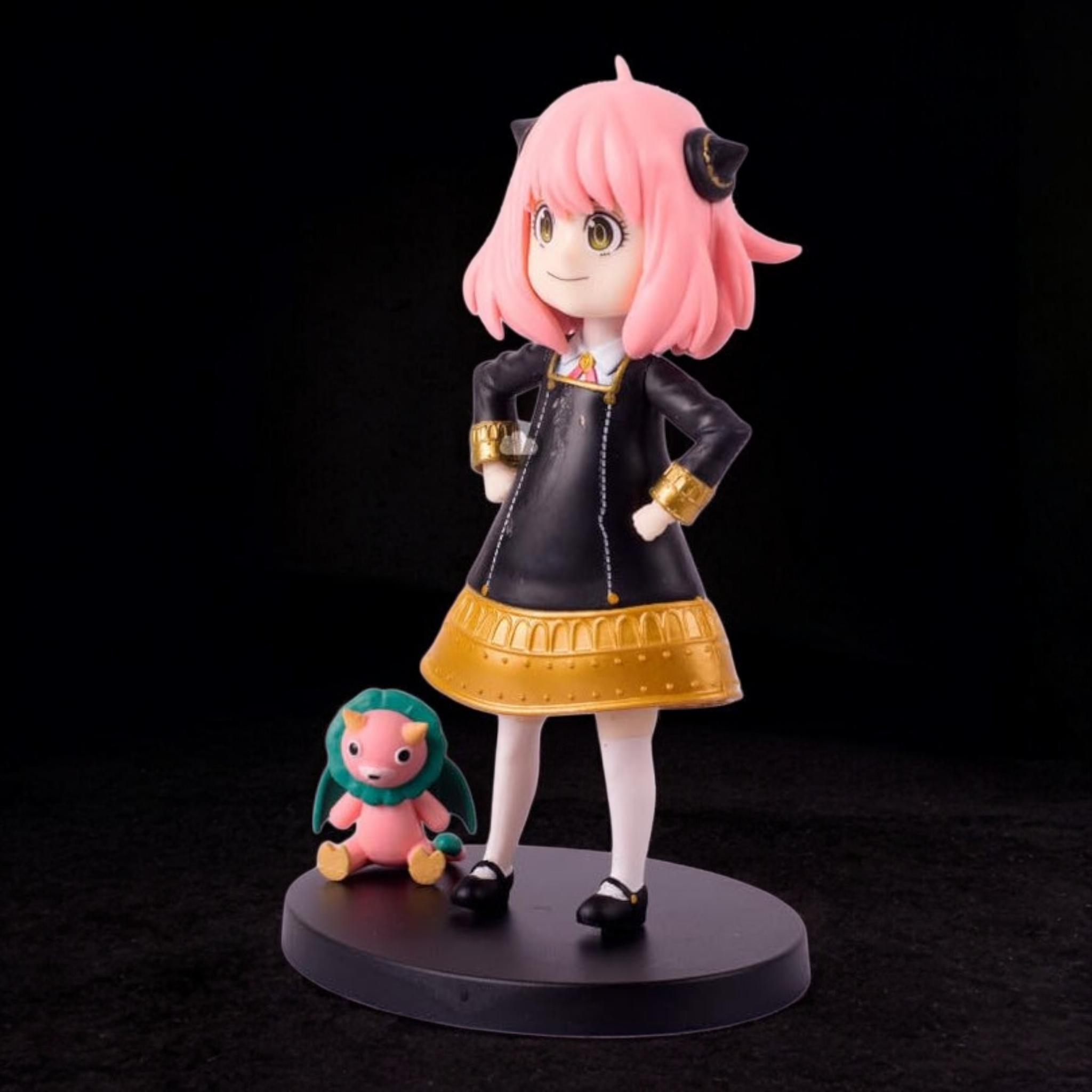 Figurine of an animated character with pink hair and a small creature on a black background