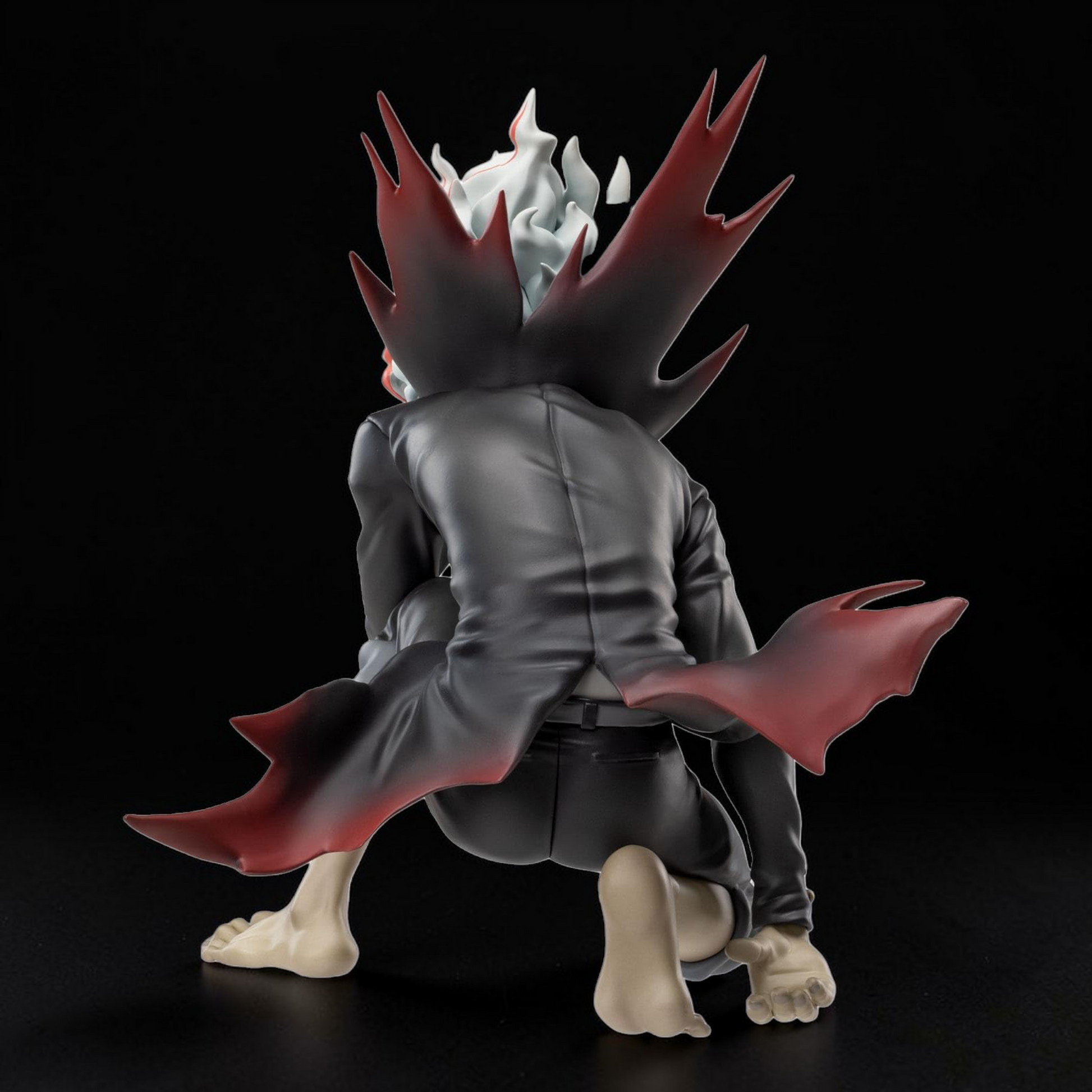 Action figure with a red and gray design on a black background