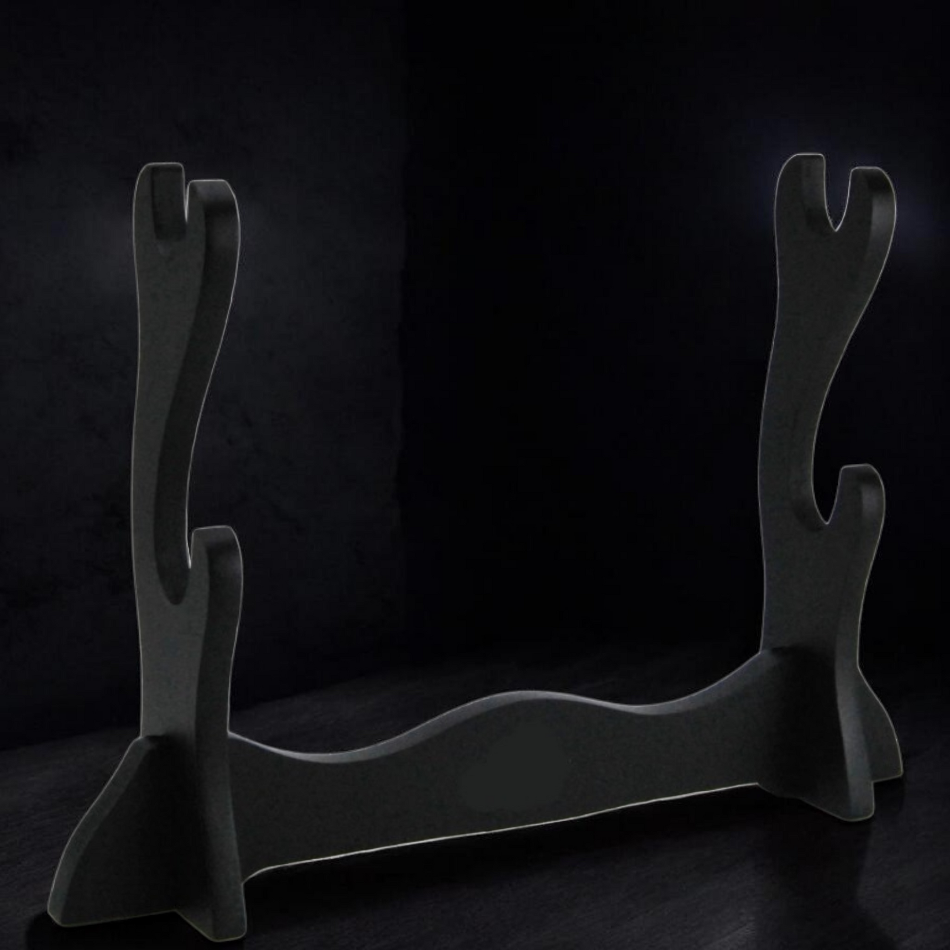 Black metal firewood holder on a dark background