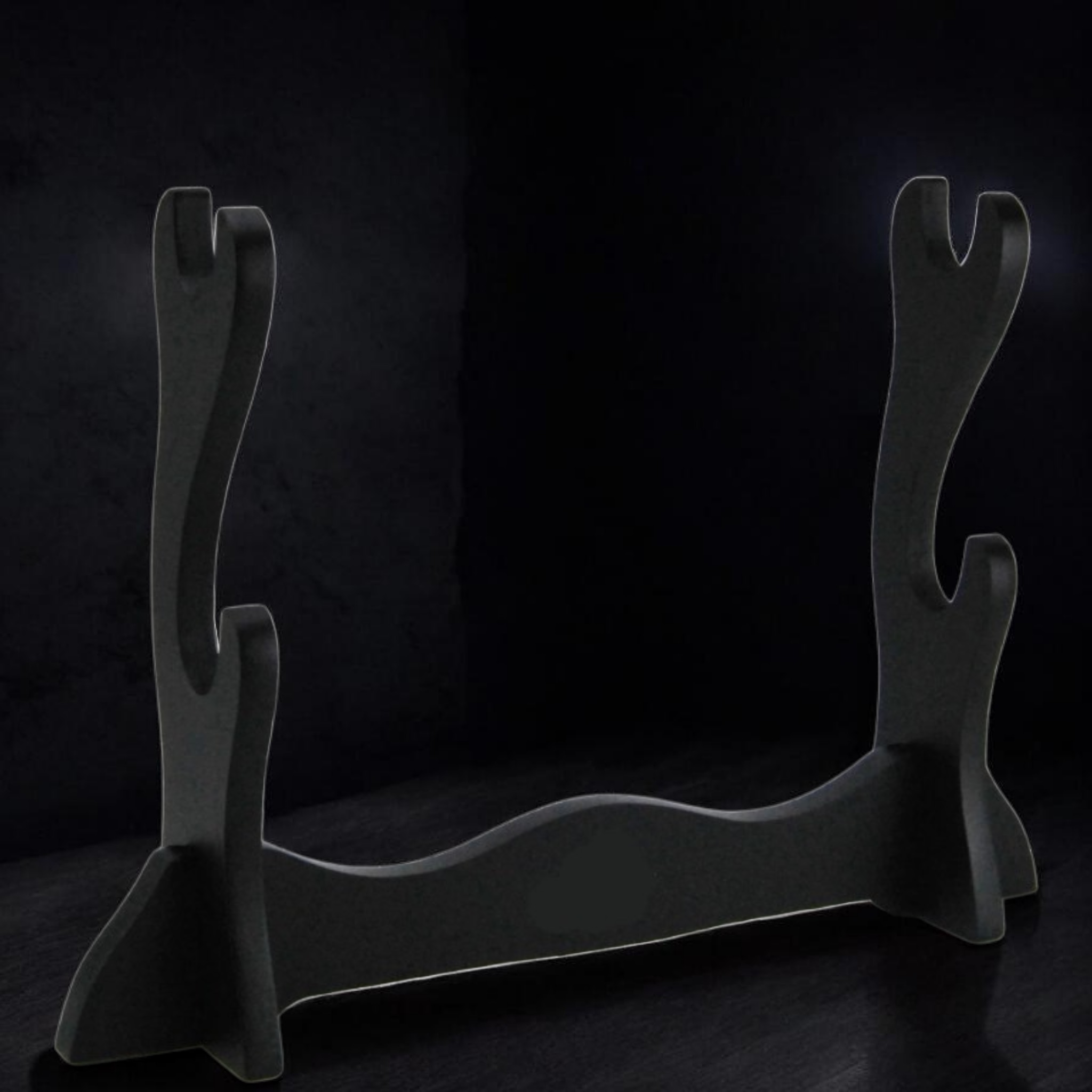 Black metal firewood holder on a dark background