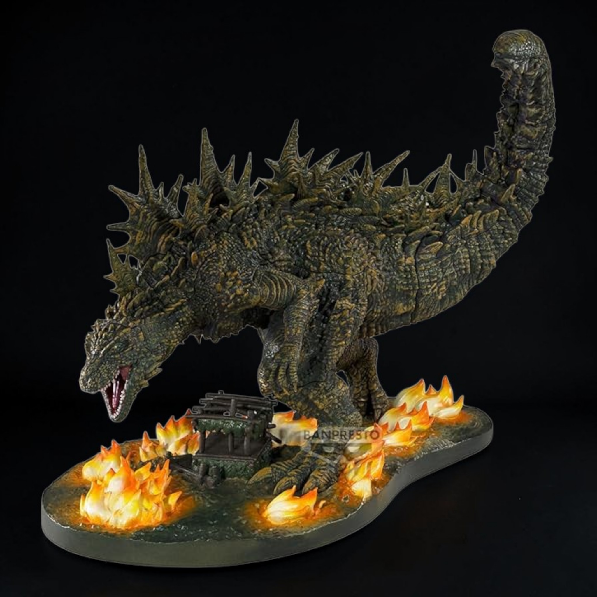Toy figure of a dragon-like creature with flames on a black background