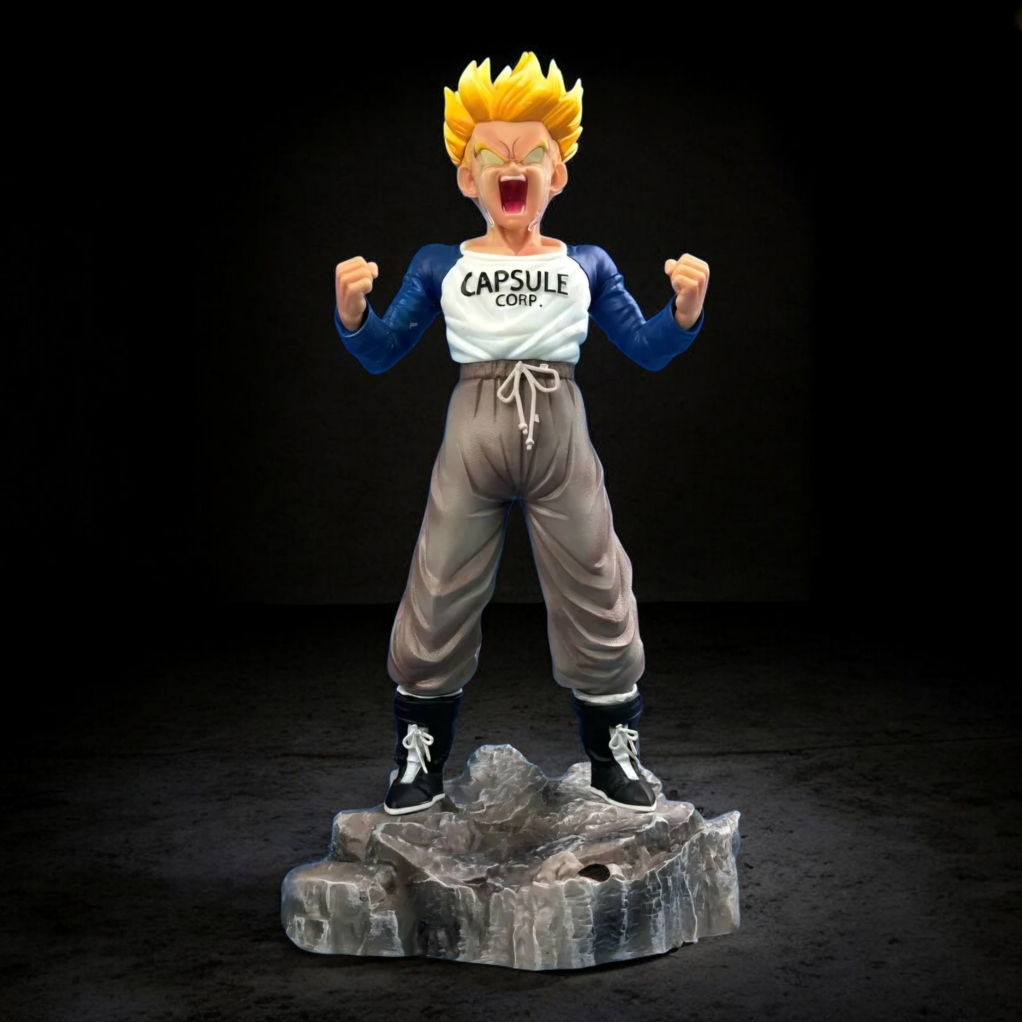 Animated character figurine with 'Capsule Corp' shirt on a dark background