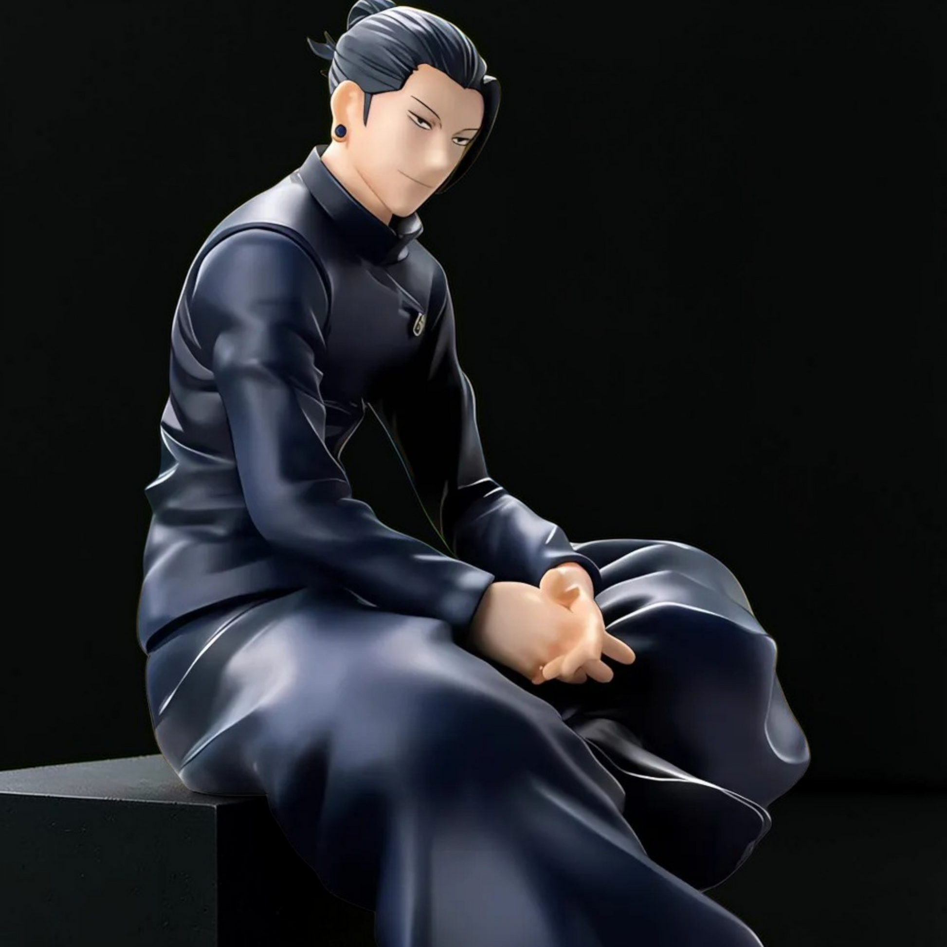 Figurine of a person in traditional attire sitting on a black background