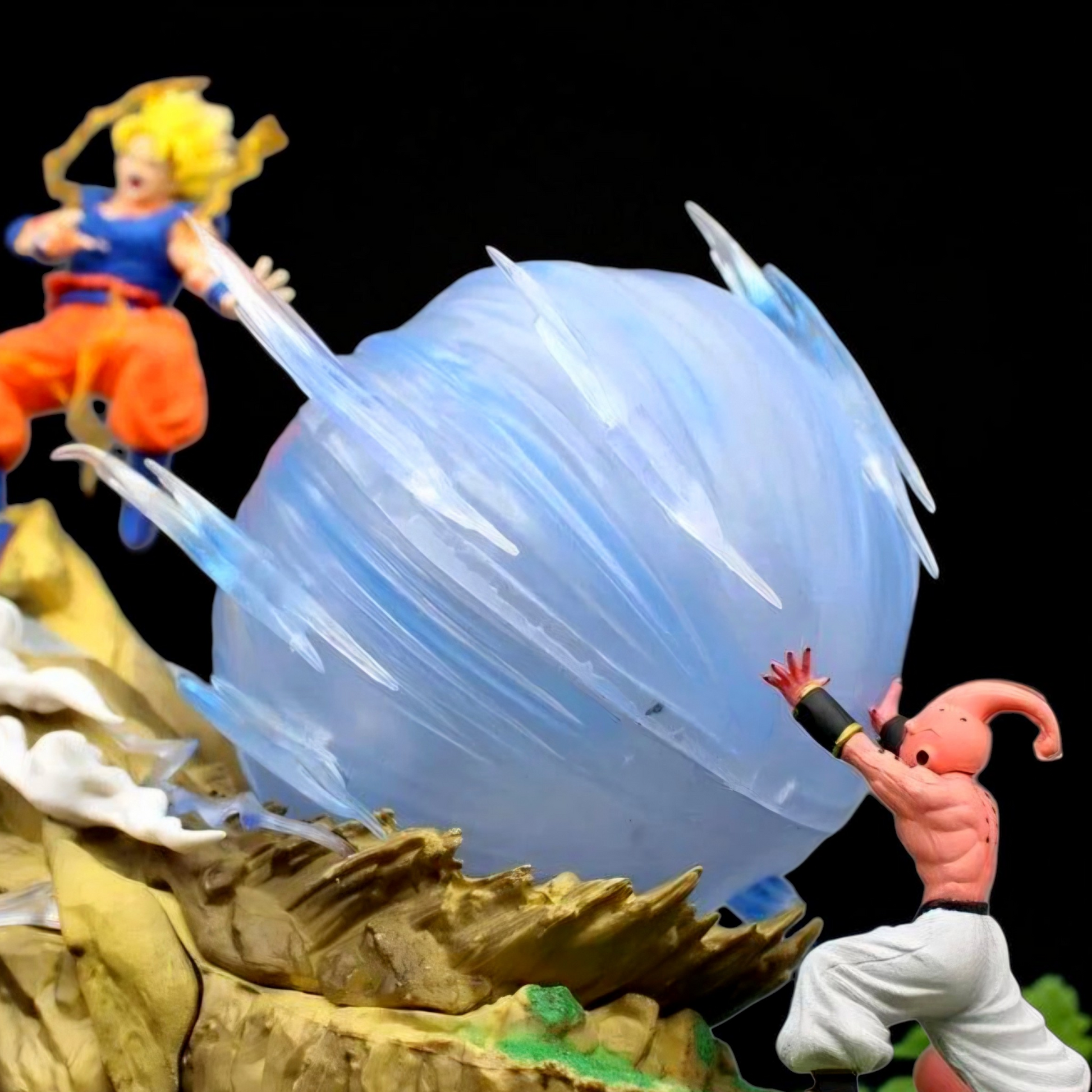 Action figures in a dynamic pose with a large blue energy ball between them on a dark background.