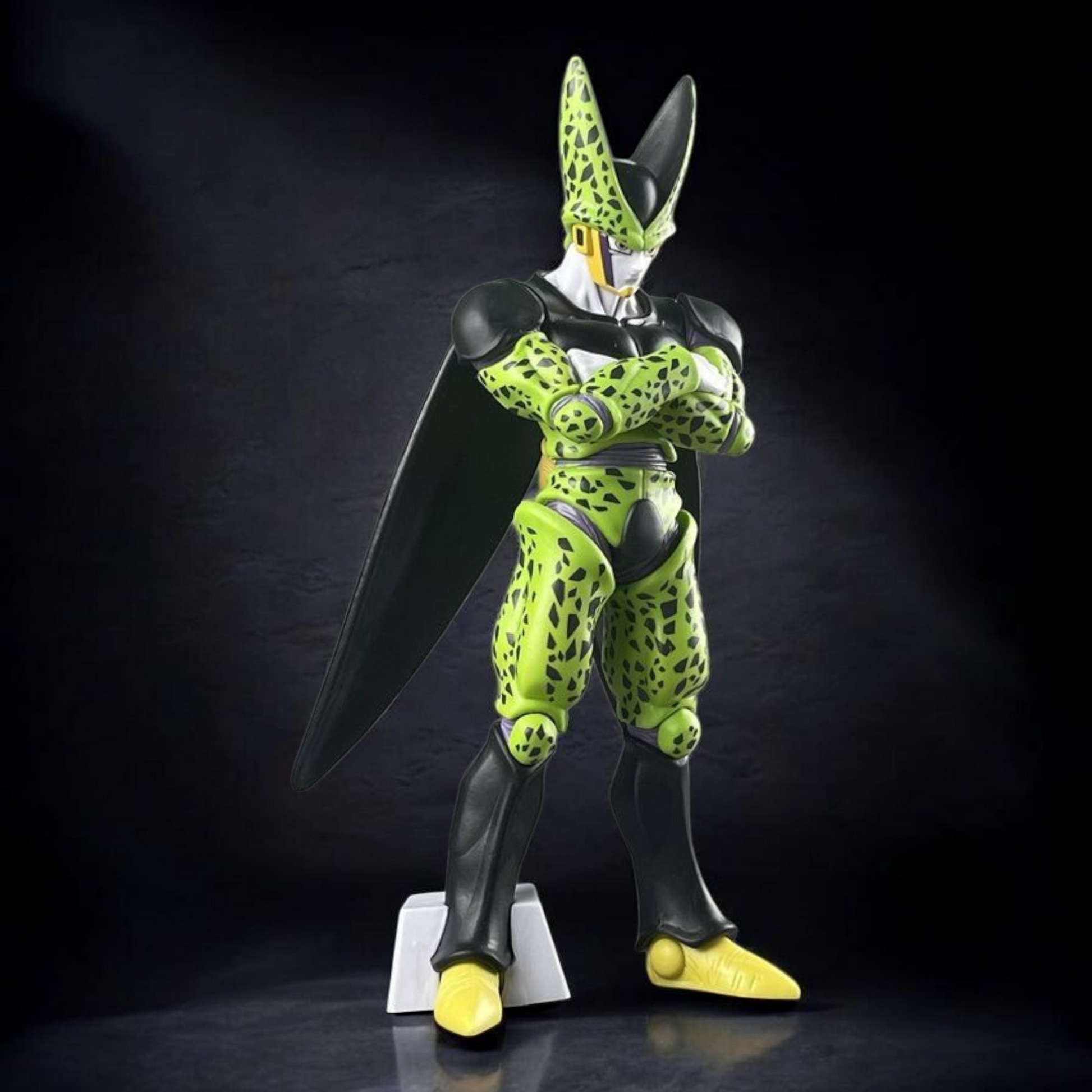 Toy figure of a character with green and black design on a dark background