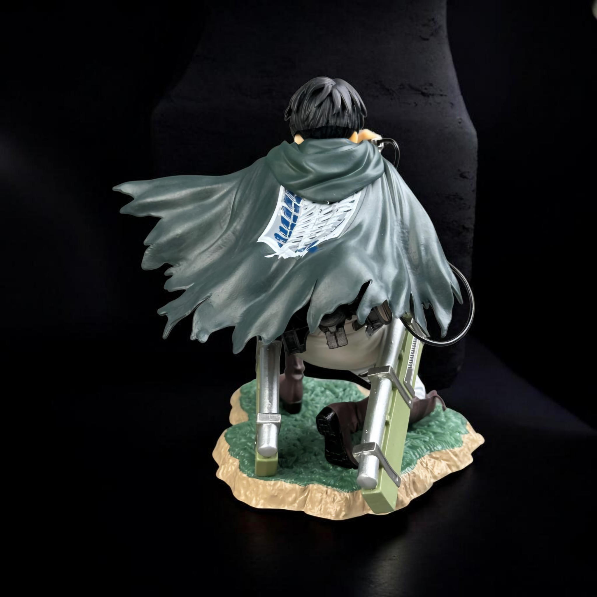 Figurine of a character with a cape and sword on a dark background