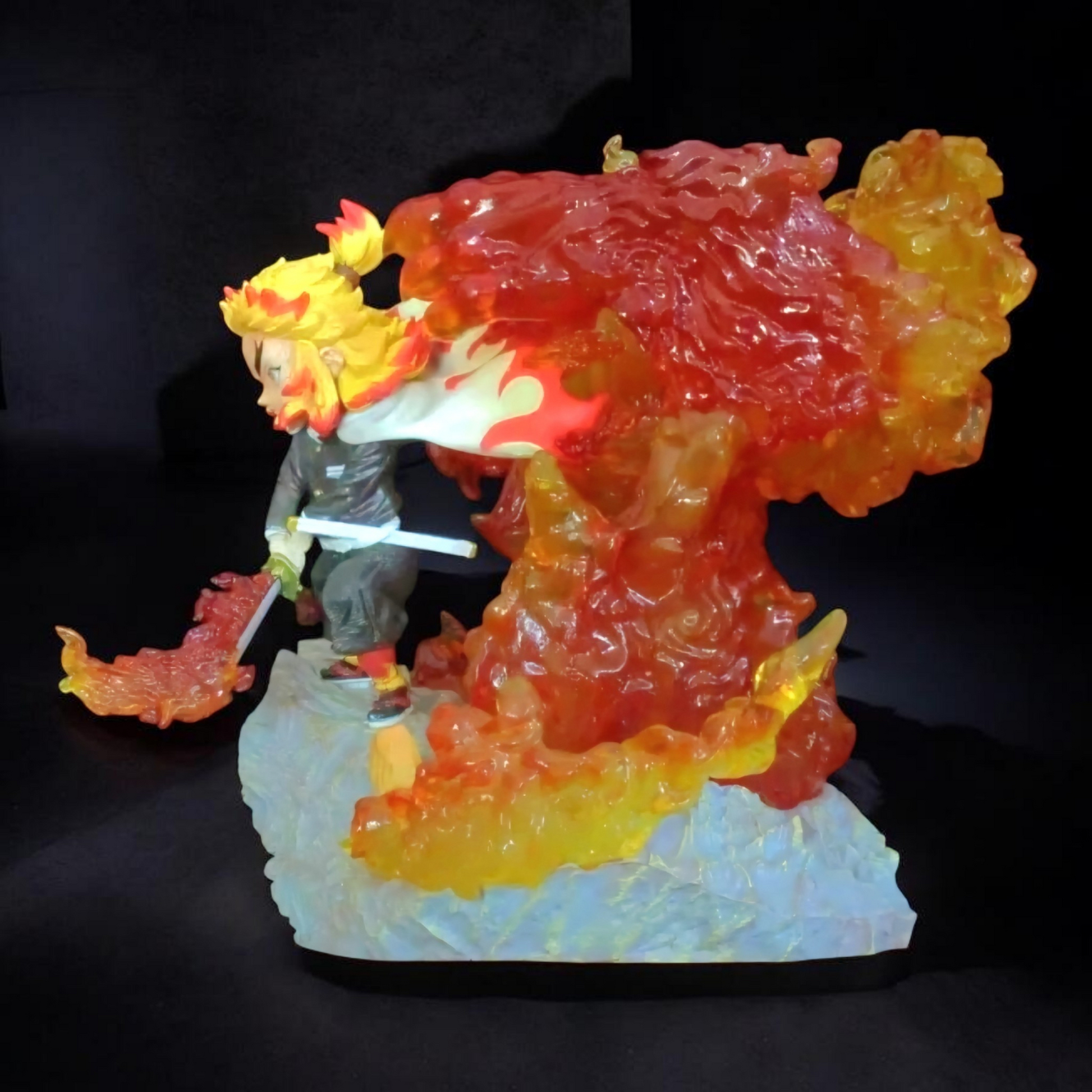 Colorful figurine of a character with flames and a sword on a dark background