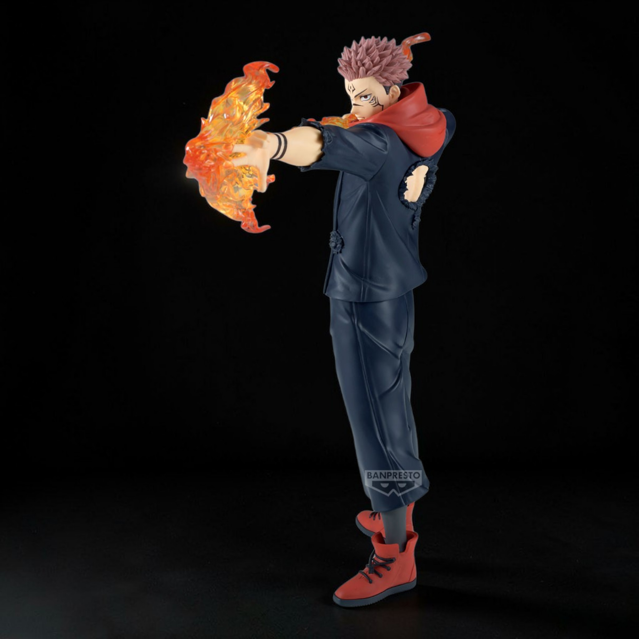 Action figure with a character holding a flaming object against a black background