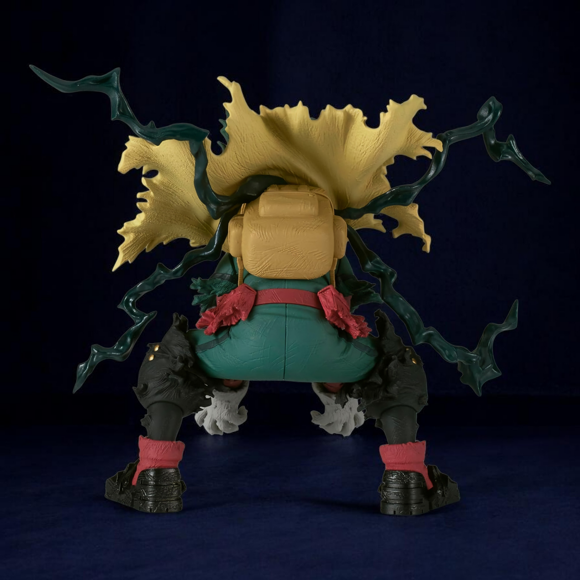 Action figure with large head and green hair on a dark background