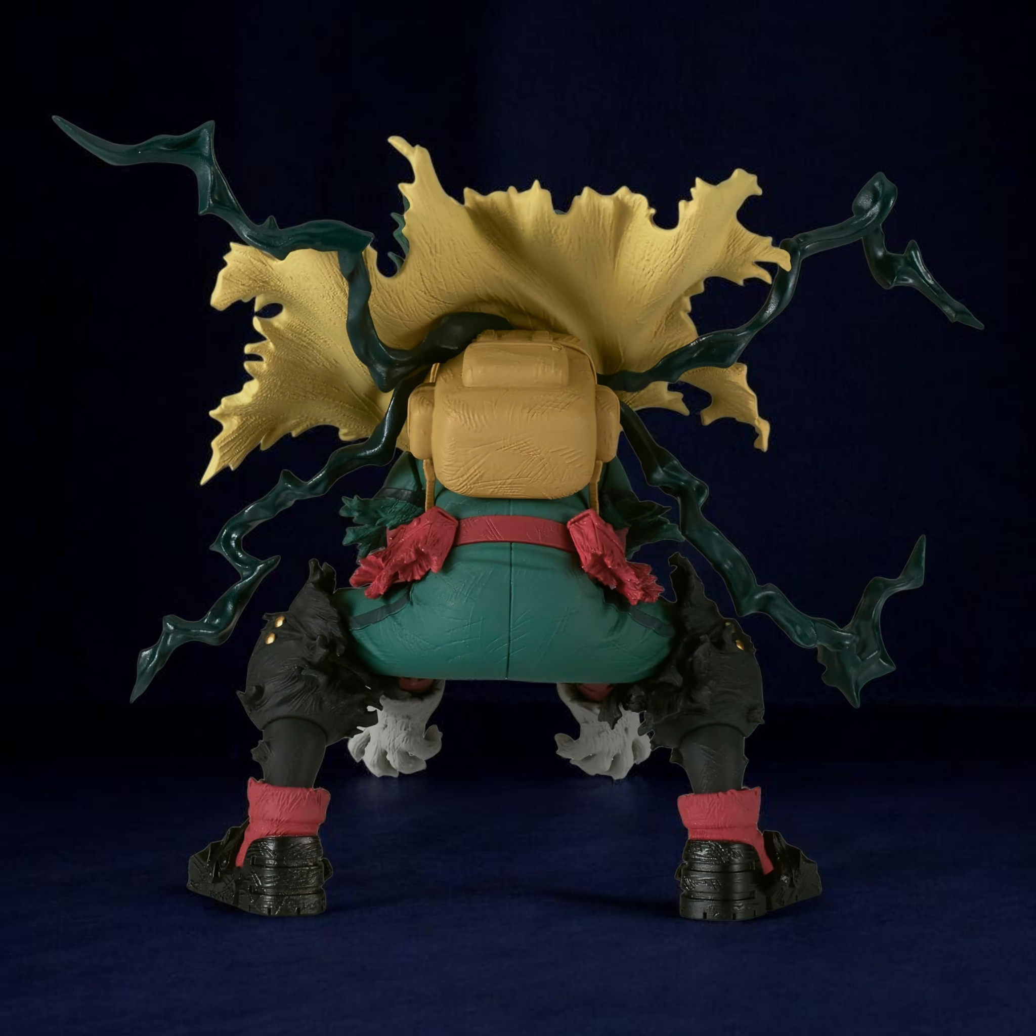 Action figure with large head and green hair on a dark background