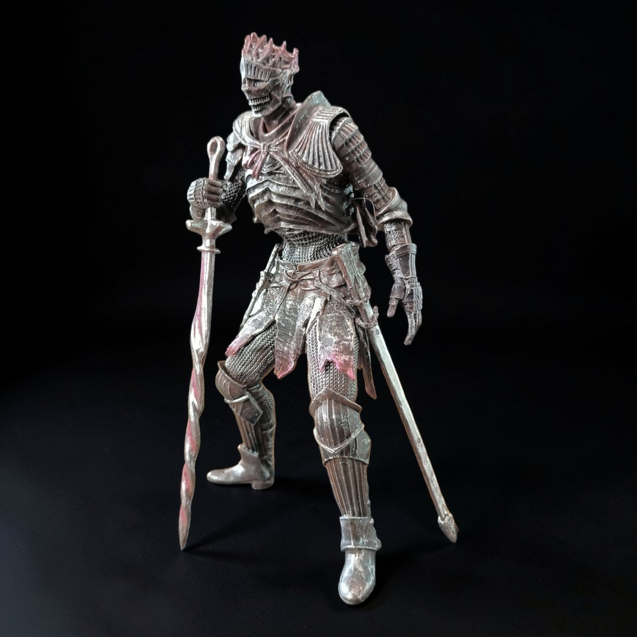 Metallic armor suit with two swords on a black background