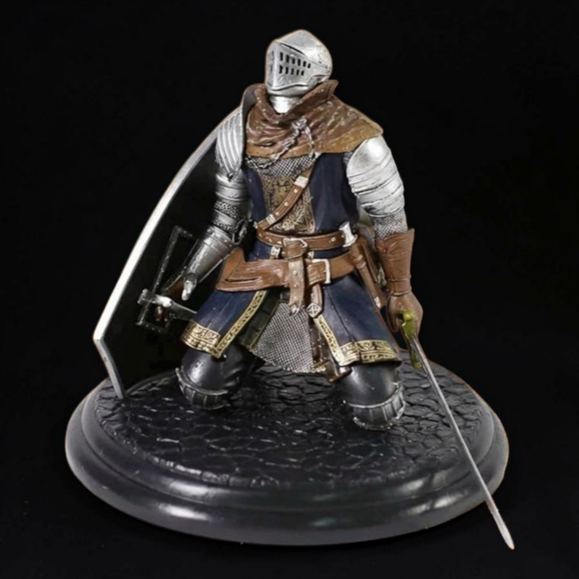 Figurine of a knight in armor on a black background