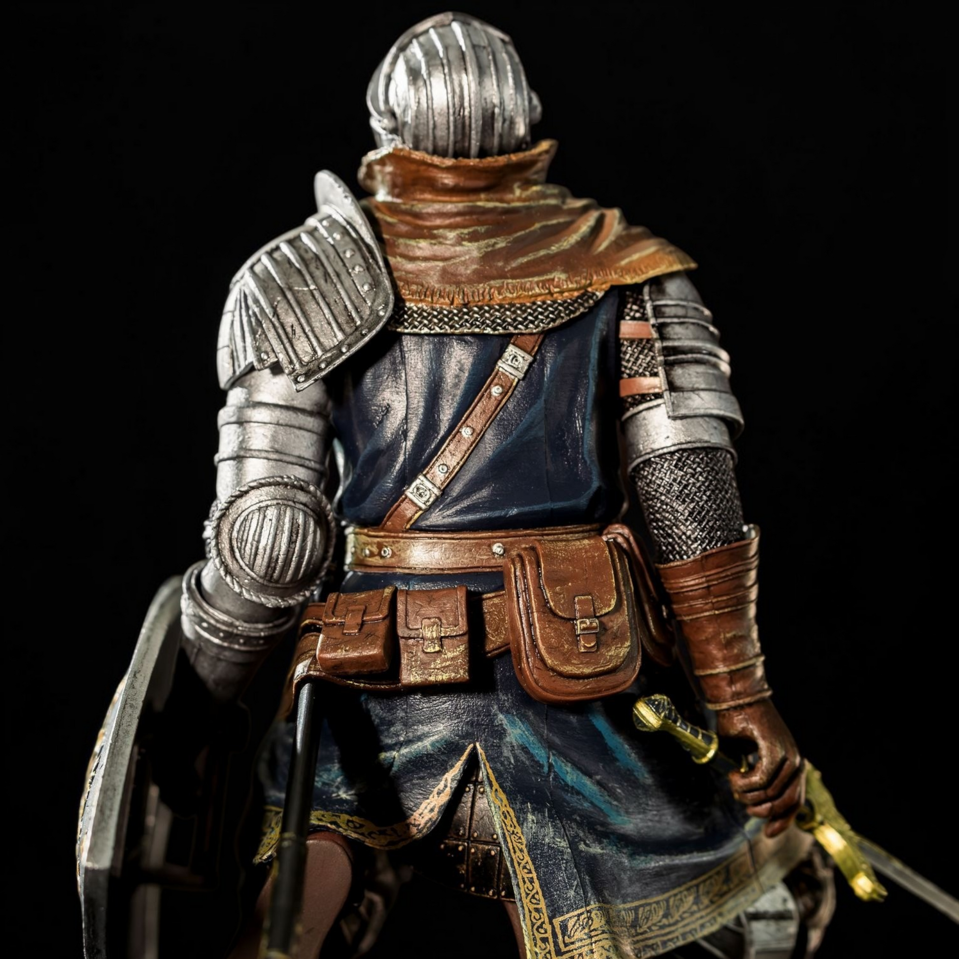 Figurine of a warrior in detailed armor with a dark background