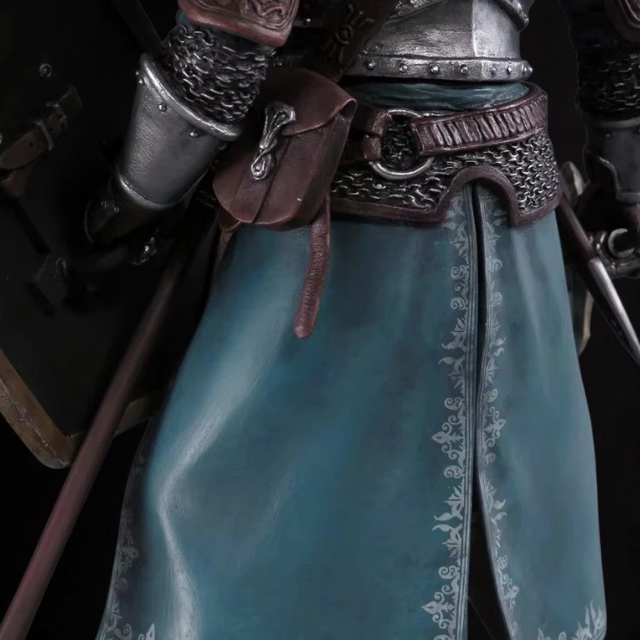 Close-up of a character in detailed armor with a blue fabric background