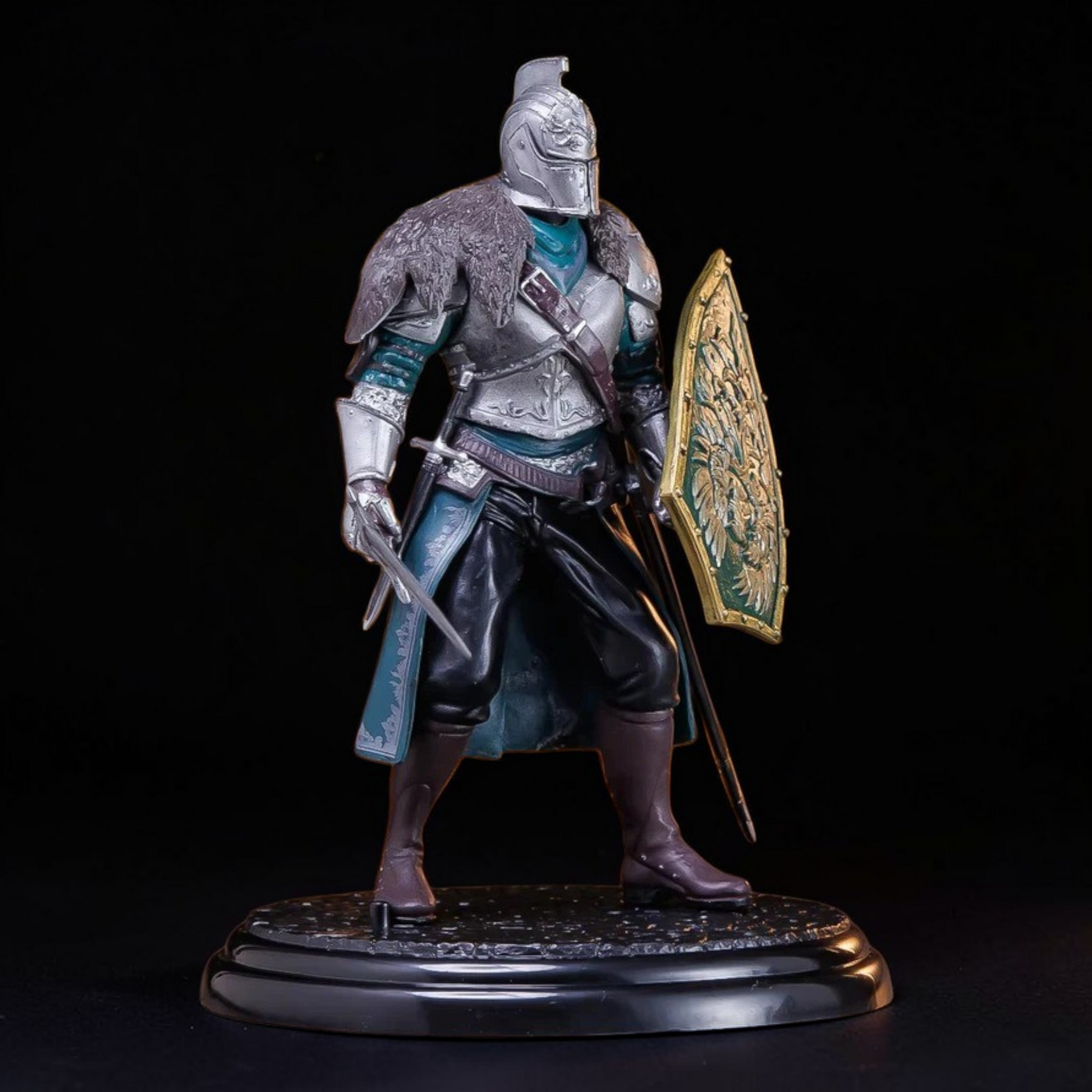Figurine of a warrior in armor with a shield and sword on a black background