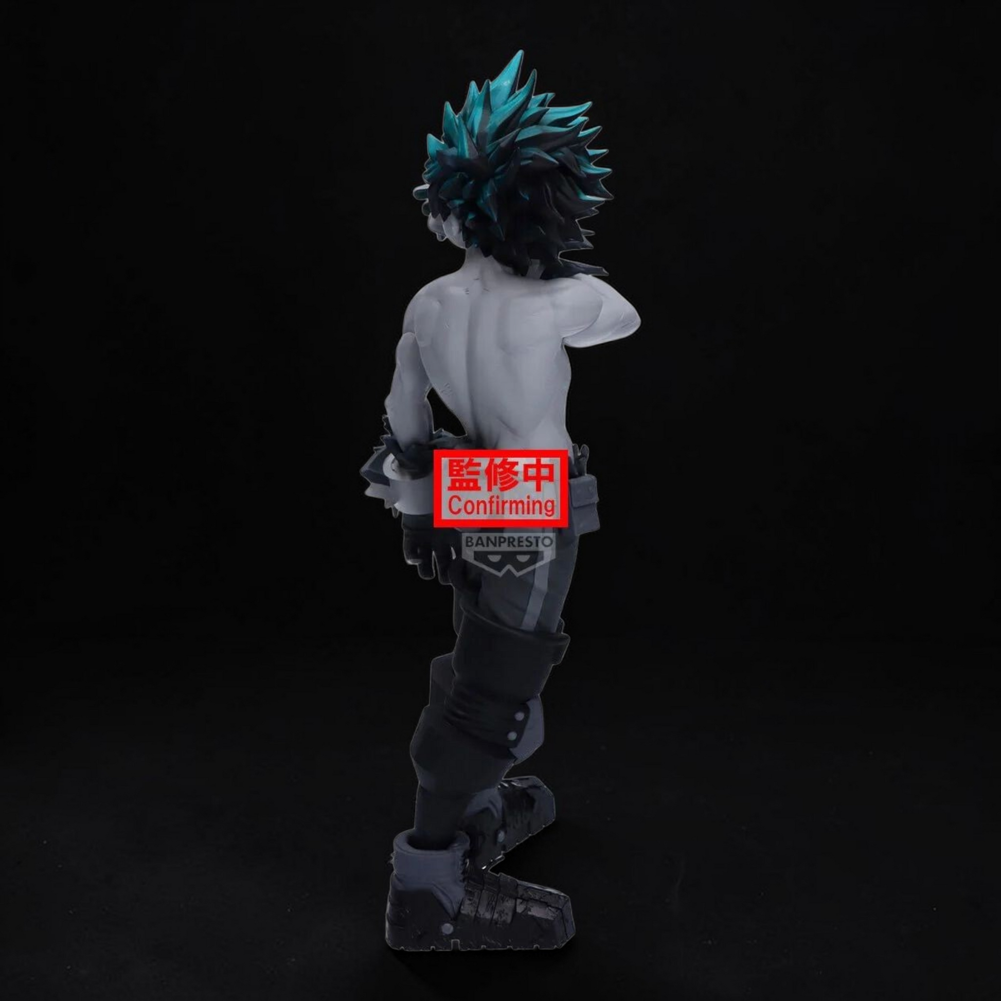 Action figure with blue hair and a red label on a black background