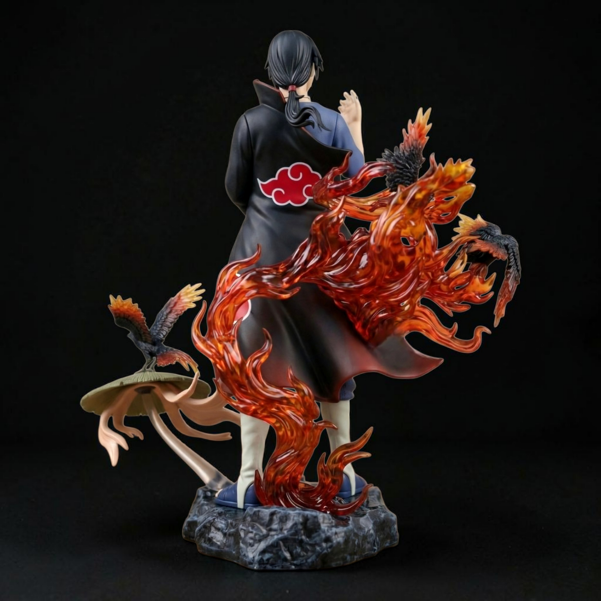 Statue of a character with a fiery creature on a dark background