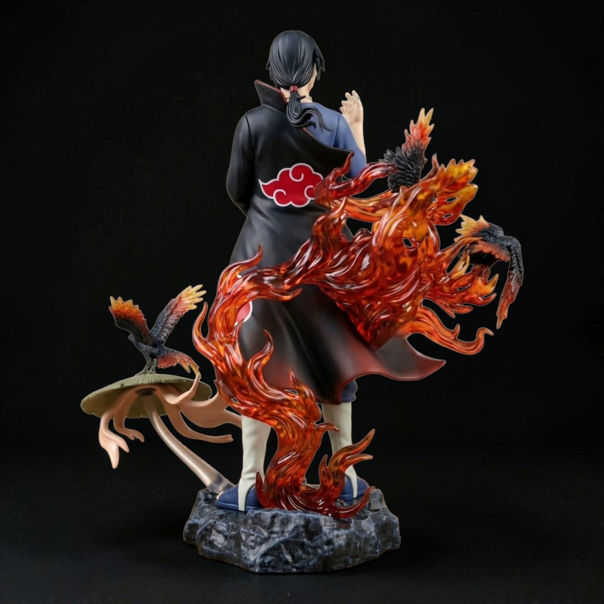 Statue of a character with a fiery creature on a dark background