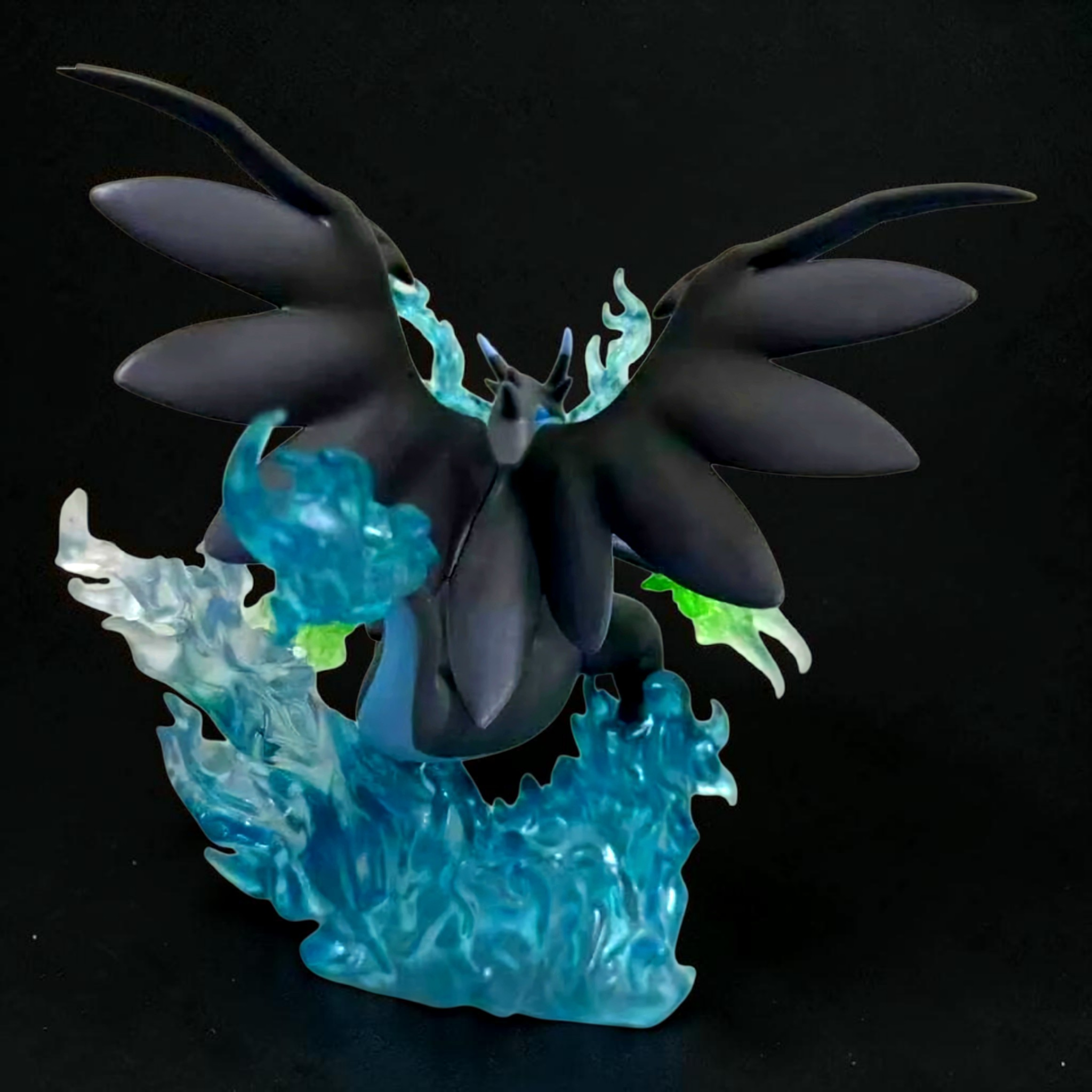 Glowing dark blue and black dragon-like creature on a black background