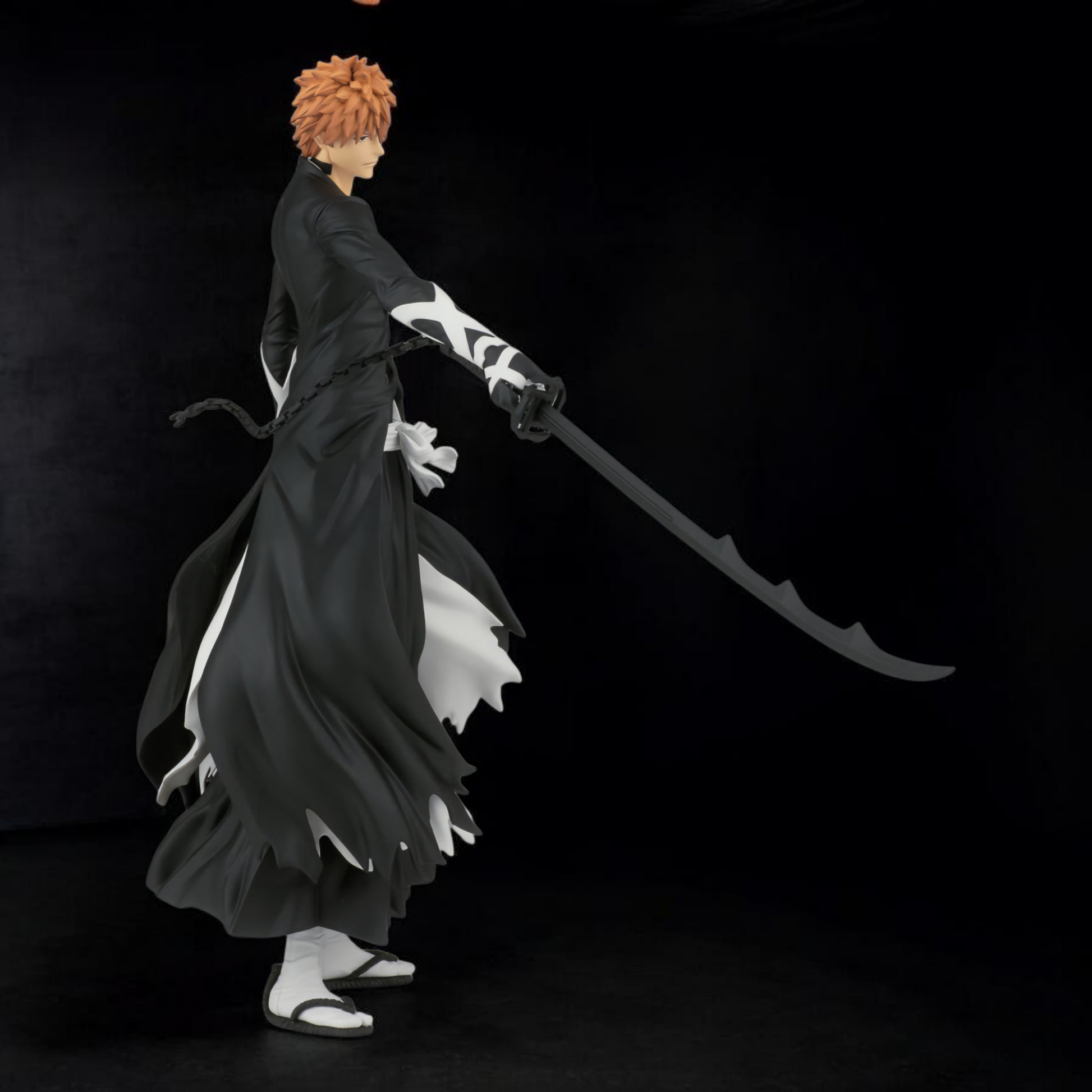 Anime character in a black kimono with a sword on a dark background