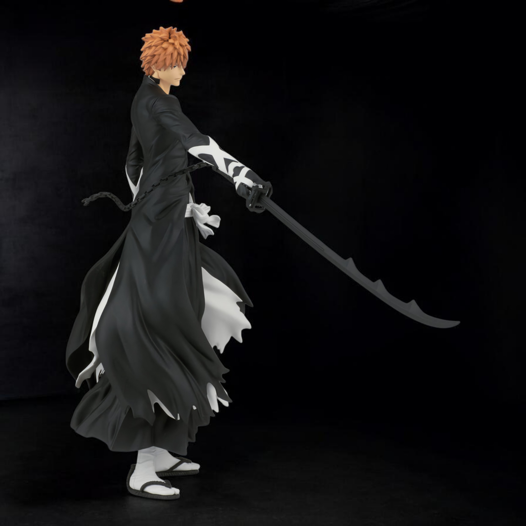 Anime character in a black kimono with a sword on a dark background