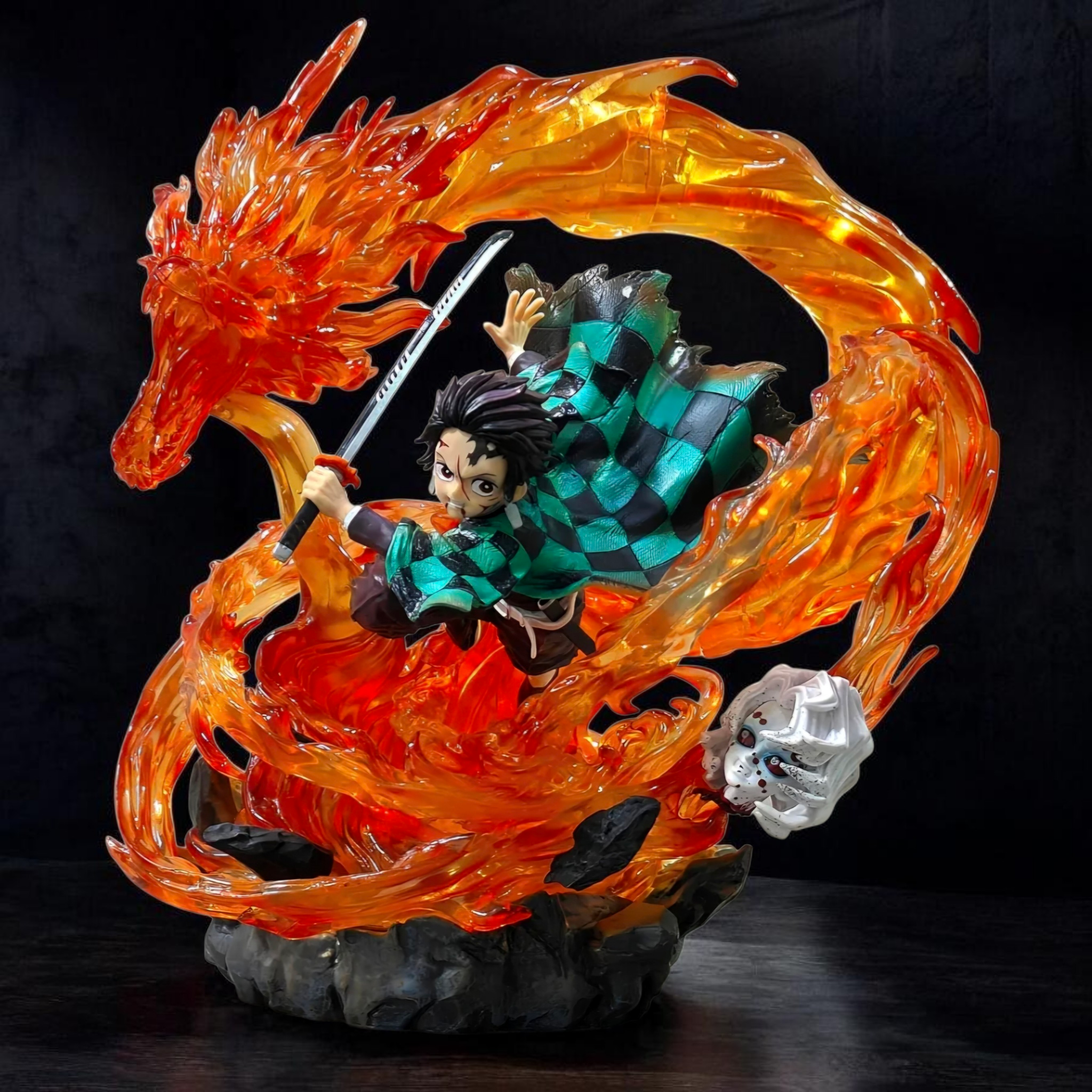 Figurine of a character with a fiery dragon and skull on a dark background