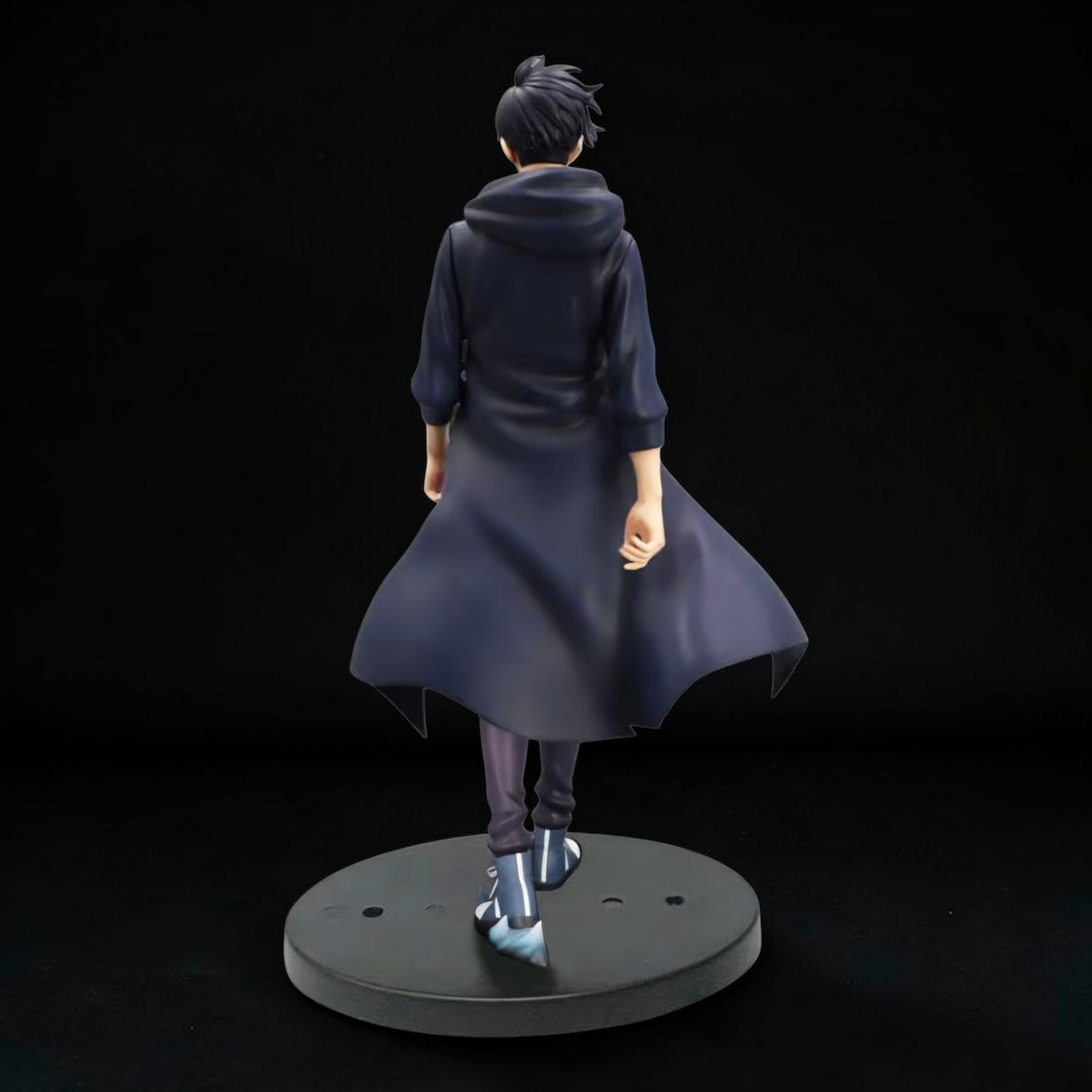 Figurine of a character in a long coat on a black background