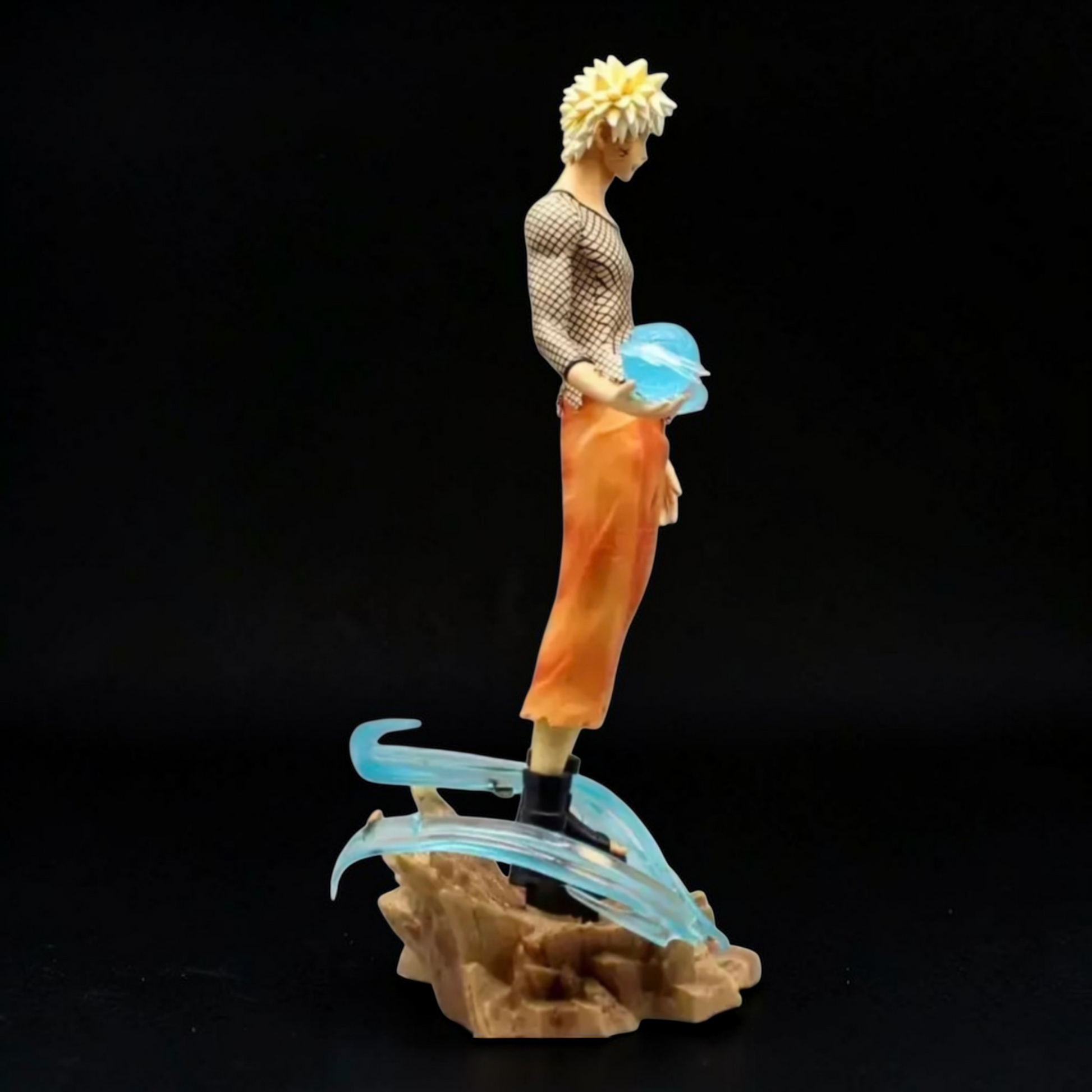 Figurine of a character with spiky hair and orange pants on a dark background
