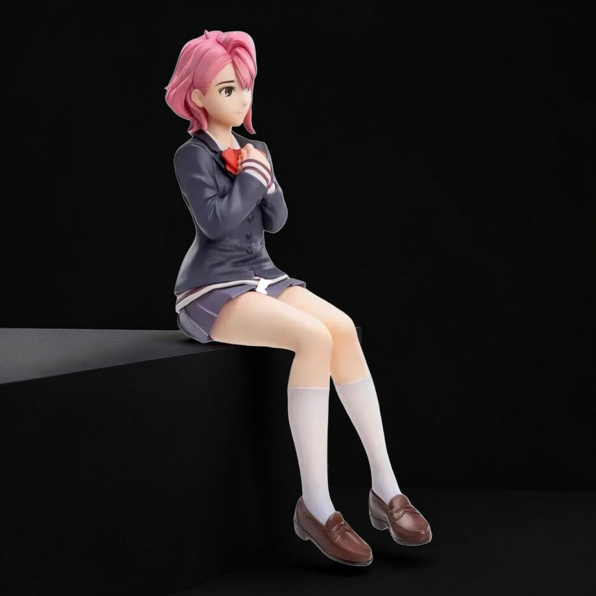 Anime character figurine with pink hair sitting on a black surface