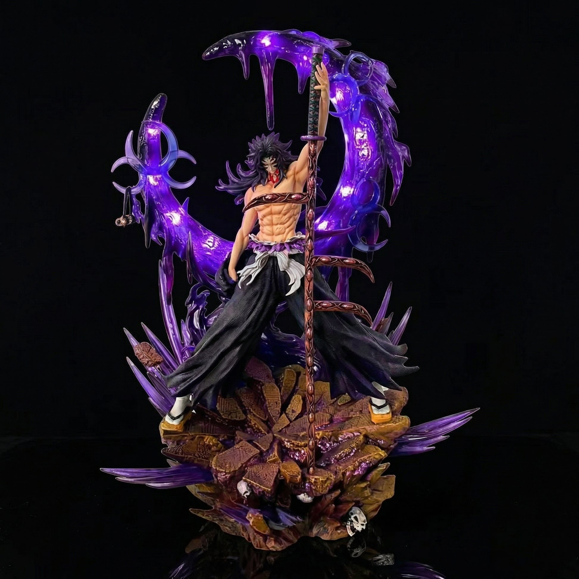 Figurine of a character with a large weapon on a dark background