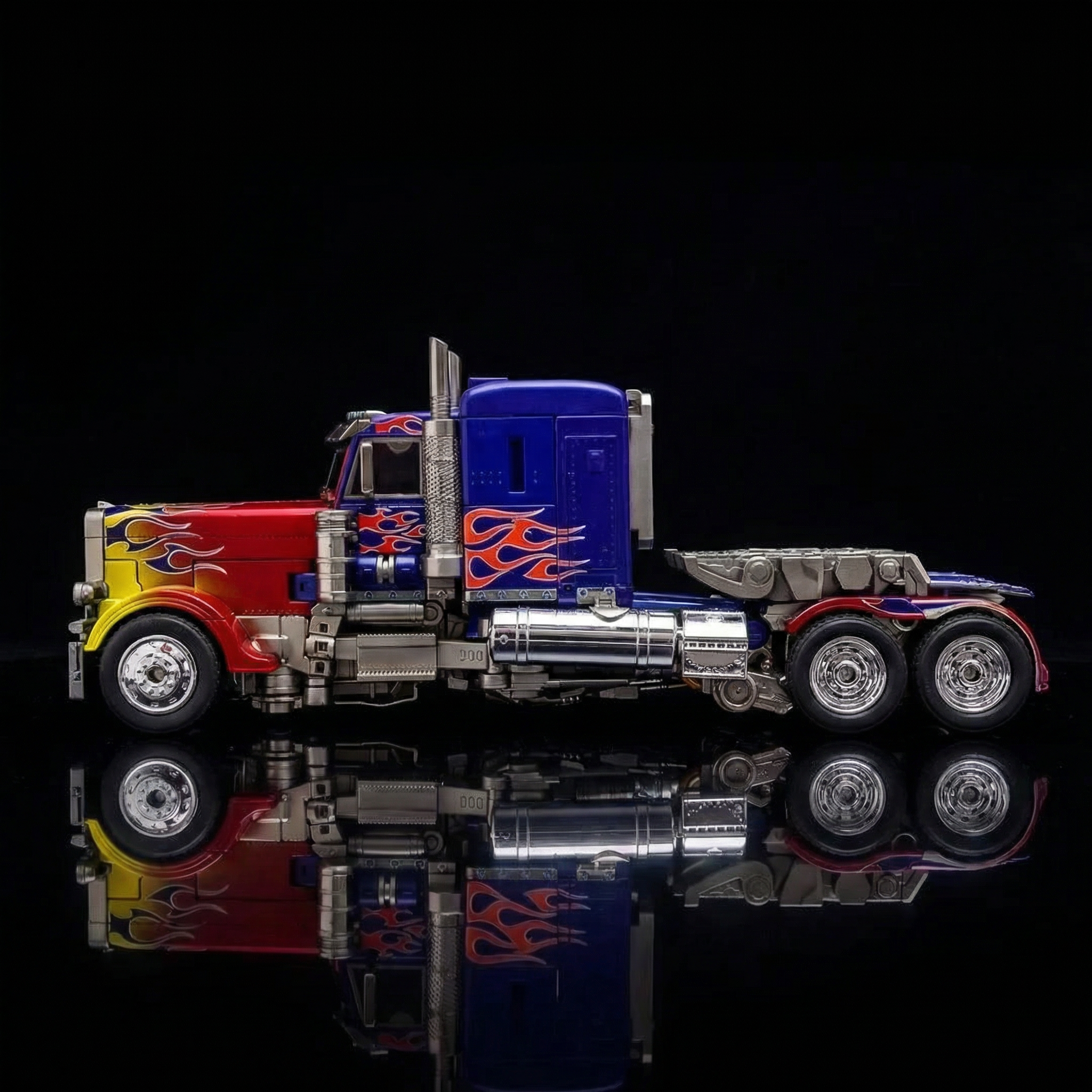 Transformable toy truck with flame design on a reflective surface