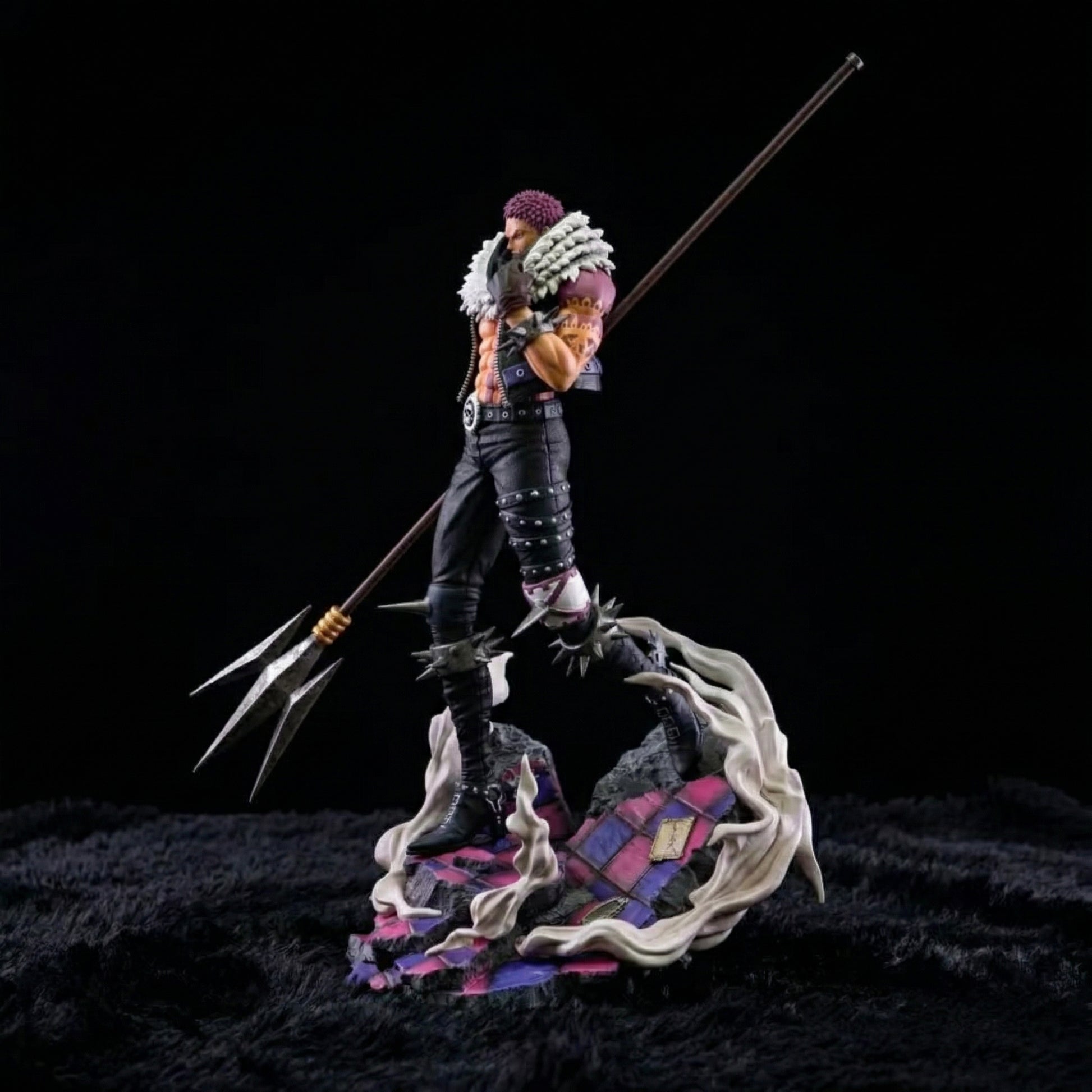 Figurine of a character with a spear on a dark background