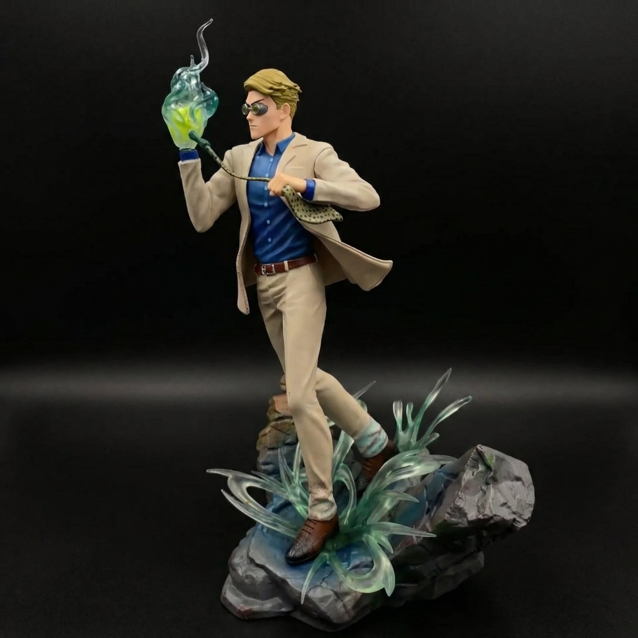 Statue of a character holding a glowing green object on a dark background