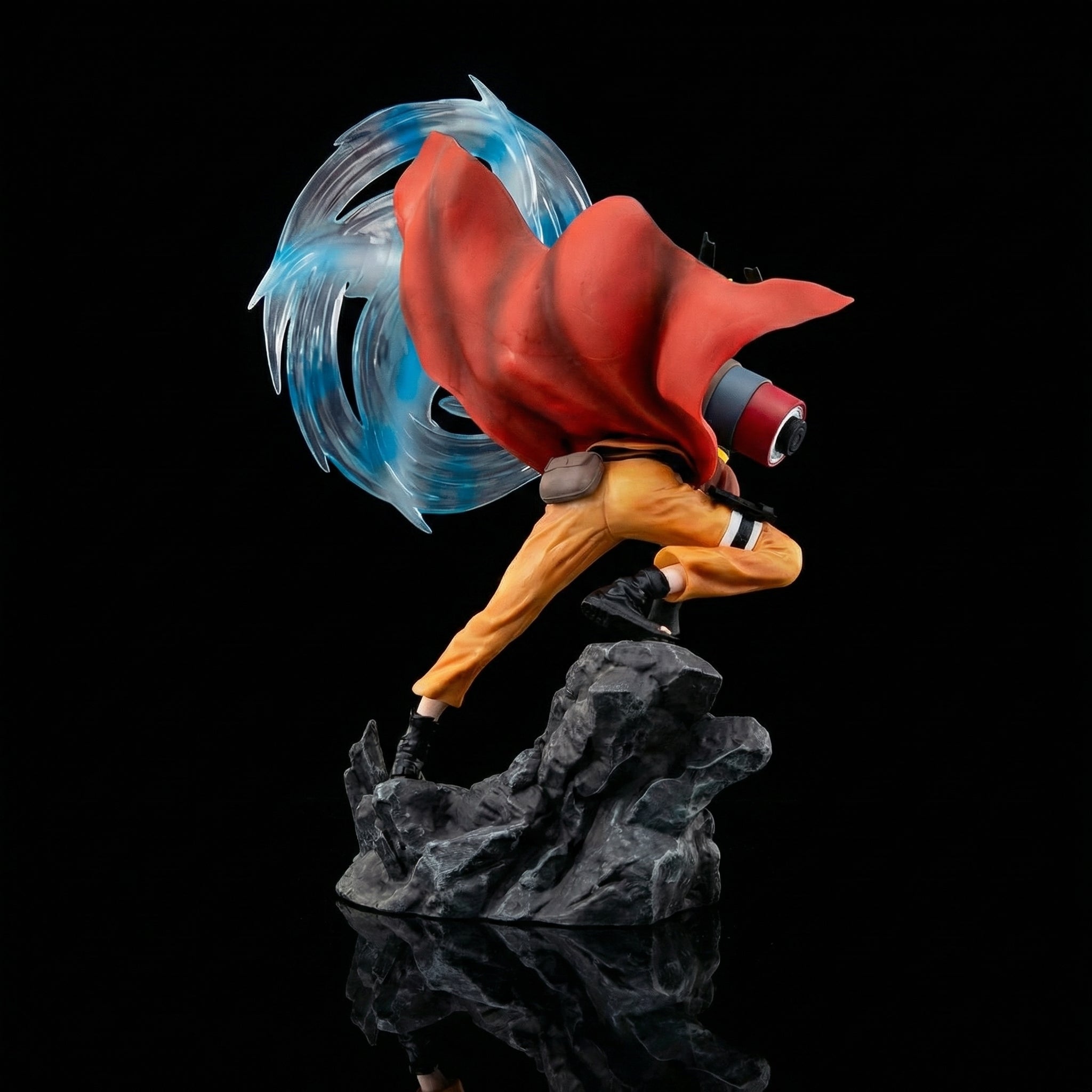 Action figure with red cape and blue energy on a black background
