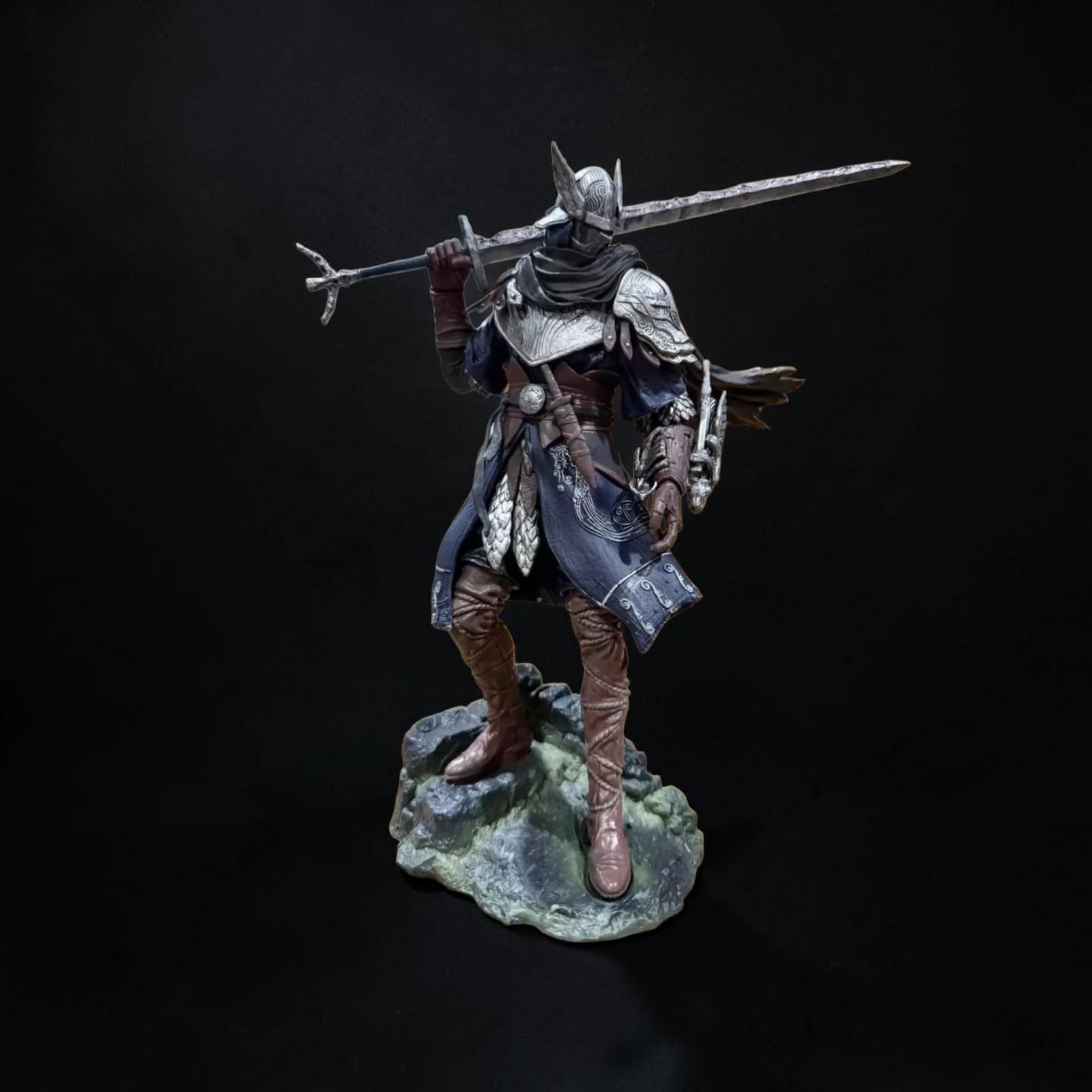 Figurine of a warrior with armor and spear on a dark background
